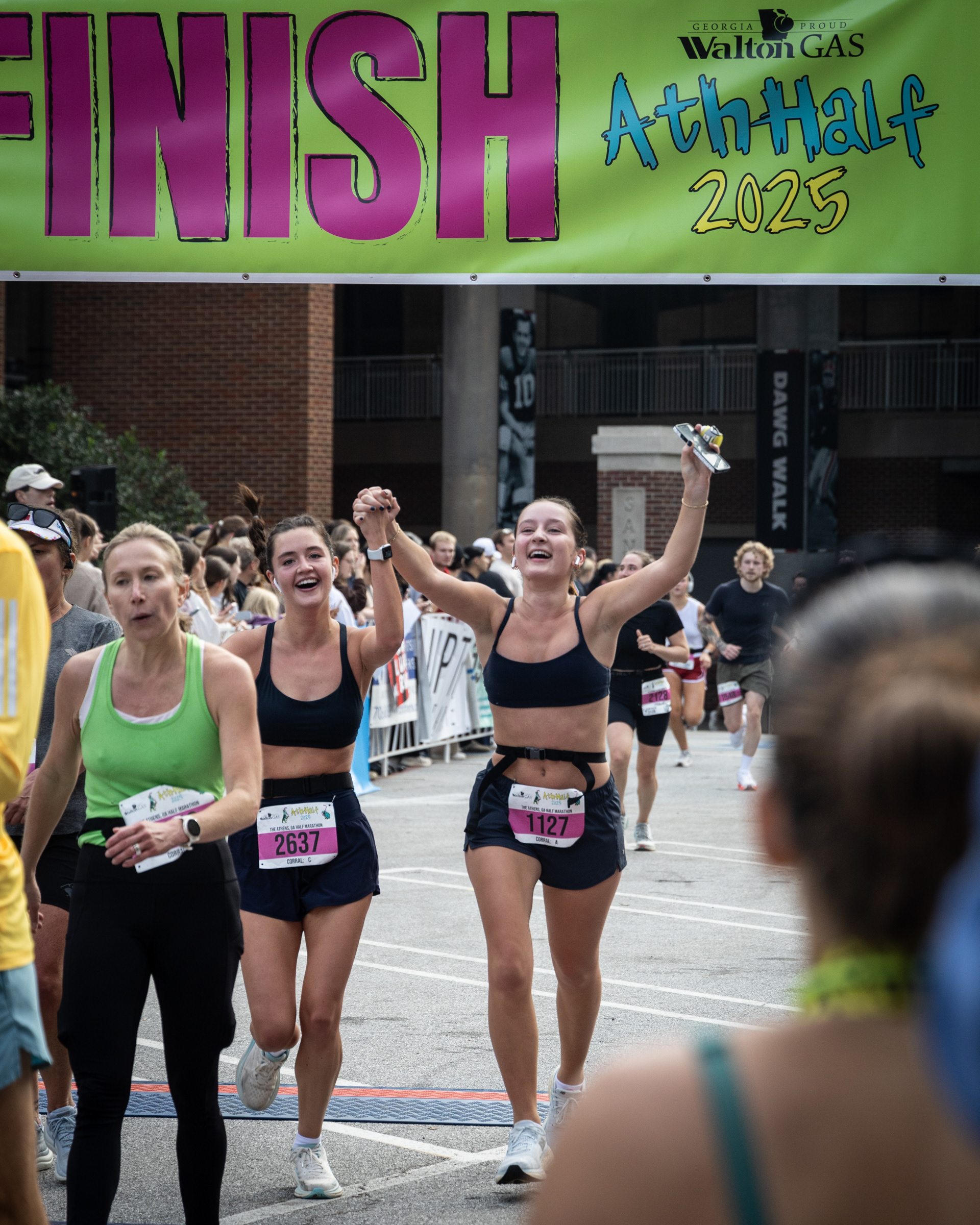 Kelsey Sanders and Laura Fudger celebrate after crossing the finish line at the AthHalf half marathon in Athens, Georgia on Sunday, Oct. 12, 2025. AthHalf is a fundraiser for Athfest Educates, which awards grants to schools, nonprofits and government agencies. (Photo/Emily Laycock)