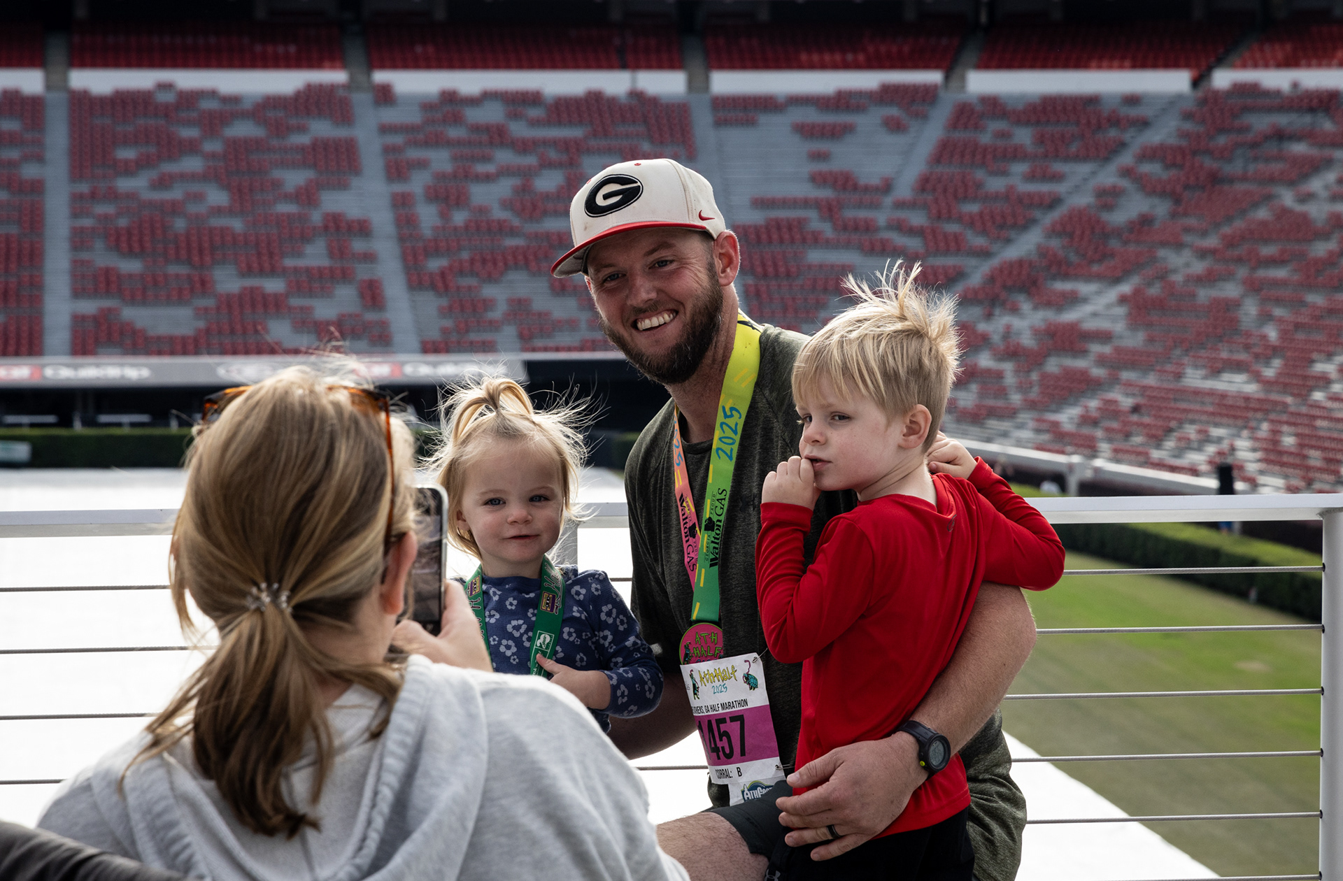 Bradley Harris poses in front of Sanford Stadium after the AthHalf half marathon in Athens, Georgia on Sunday, Oct. 12, 2025. AthHalf is a fundraiser for Athfest Educates, which awards grants to schools, nonprofits and government agencies. (Photo/Emily Laycock)