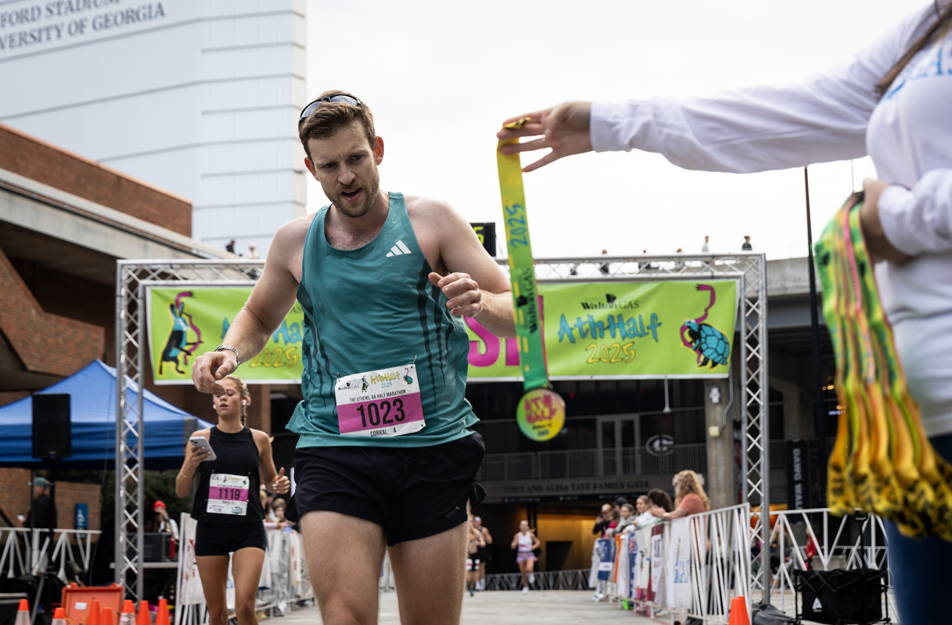 Grant Lanser collects his medal after crossing the finish line at the AthHalf half marathon in Athens, Georgia on Sunday, Oct. 12, 2025. AthHalf is a fundraiser for Athfest Educates, which awards grants to schools, nonprofits and government agencies. (Photo/Emily Laycock)