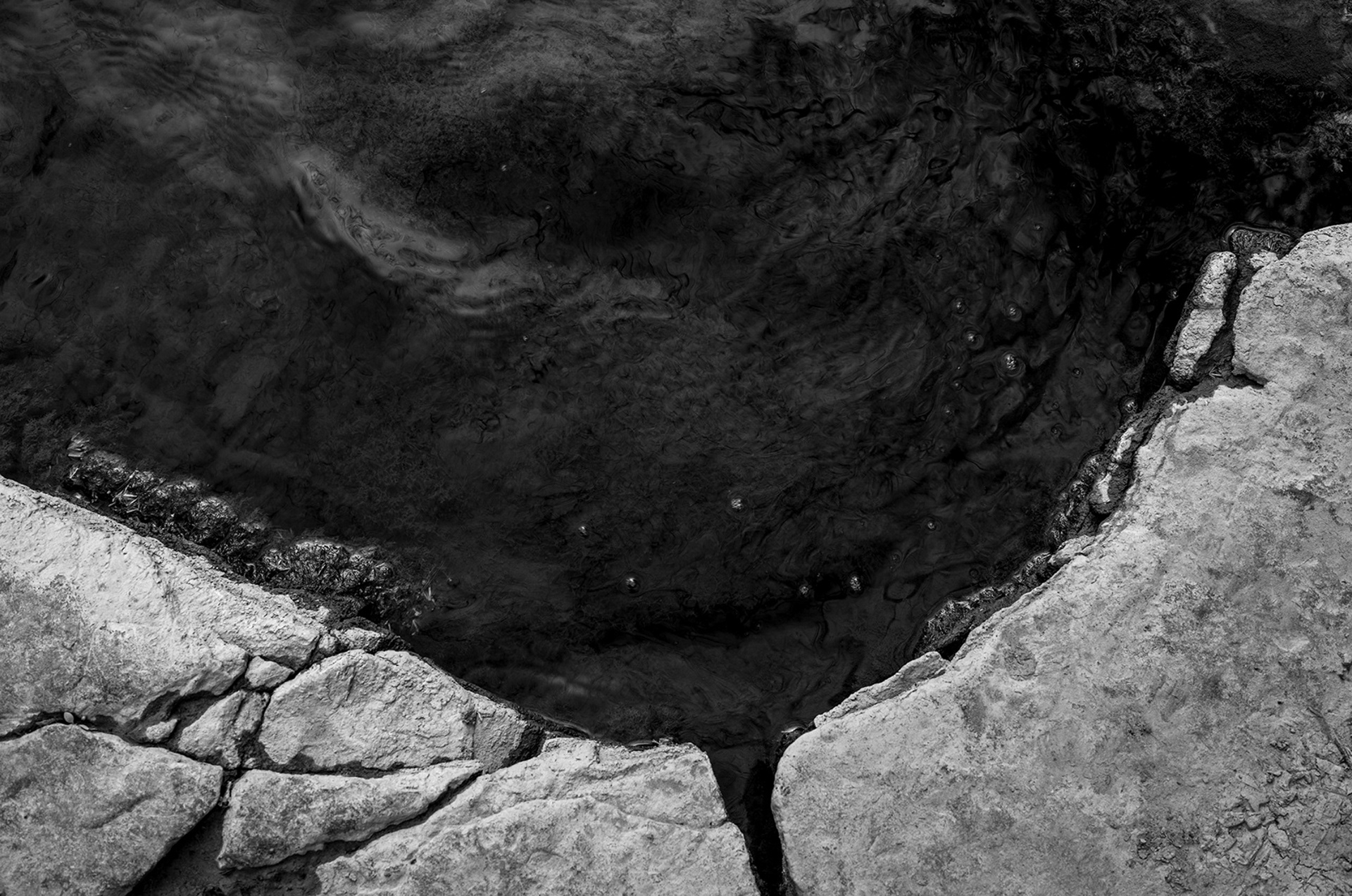 Minimal composition of two rocks divided by reflected light. Visual artwork by Bucchianeri, professional photographer and artist.