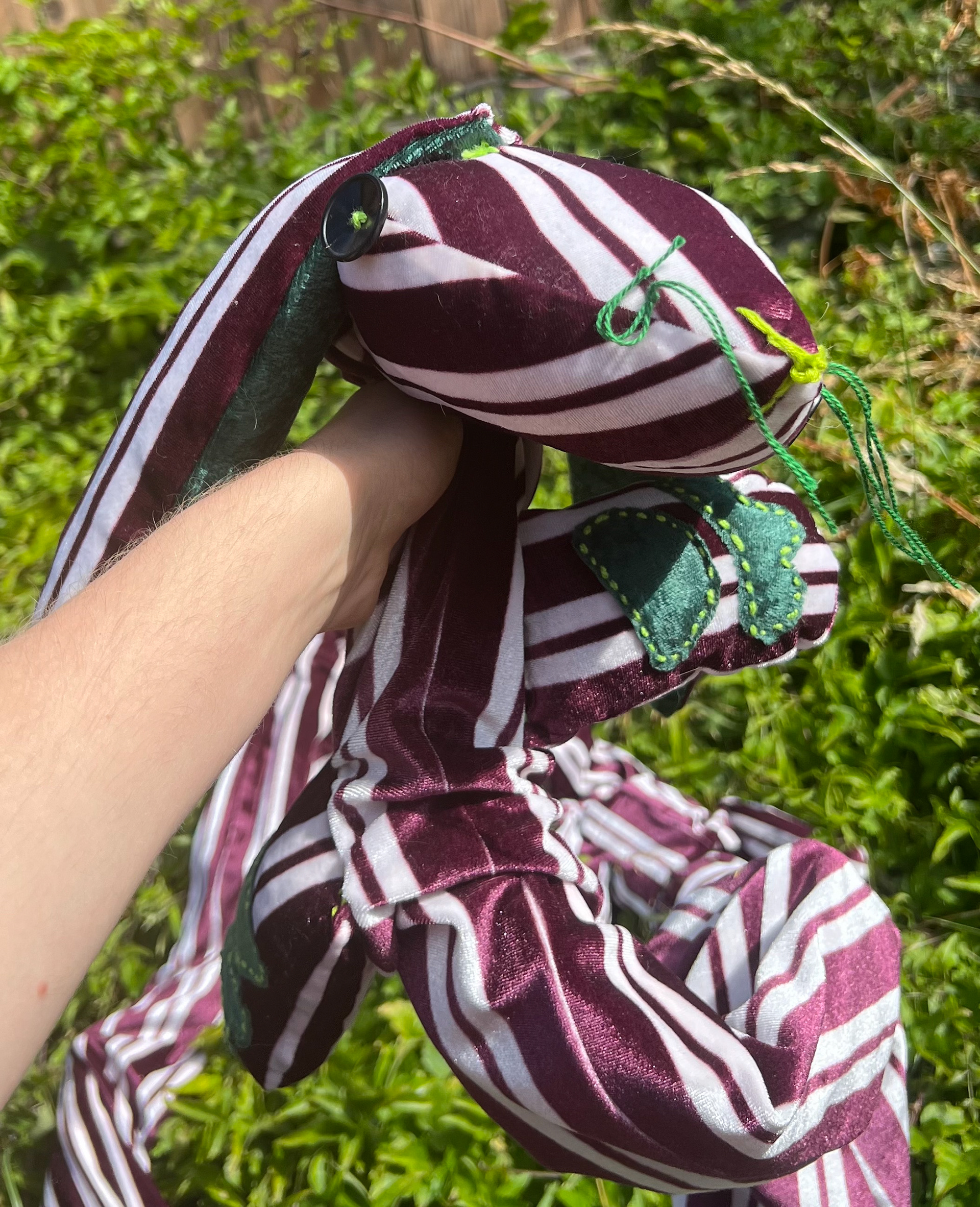 (closeup) 10 ft long striped bunny worm with hand-sewn details and soft internal skeleton
