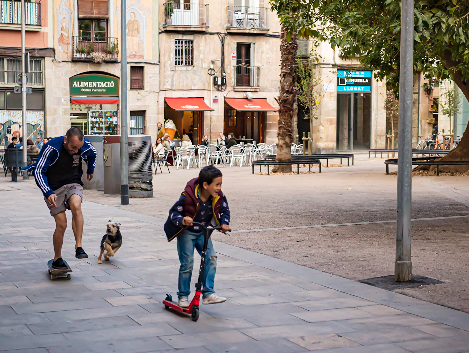 Father and son in a city square of Barcelona.