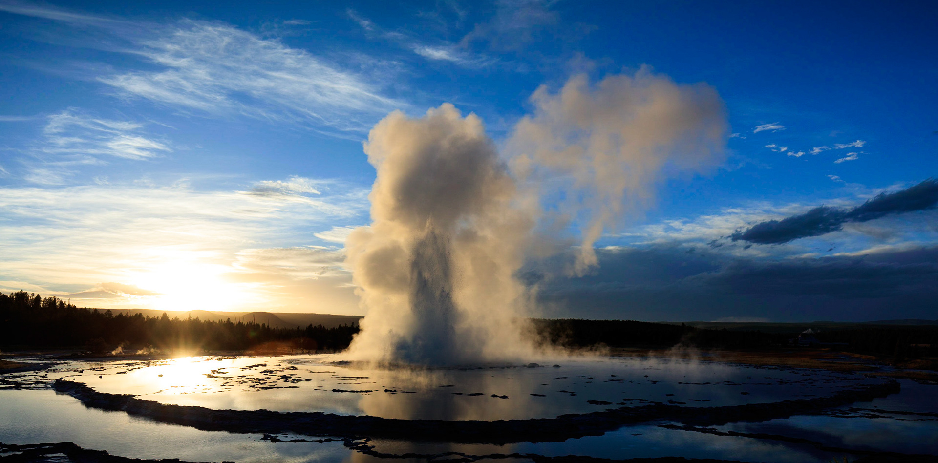 The Great Fountain on Firehole Lake Drive in Yellowstone National Park, illuminated by the setting sun.