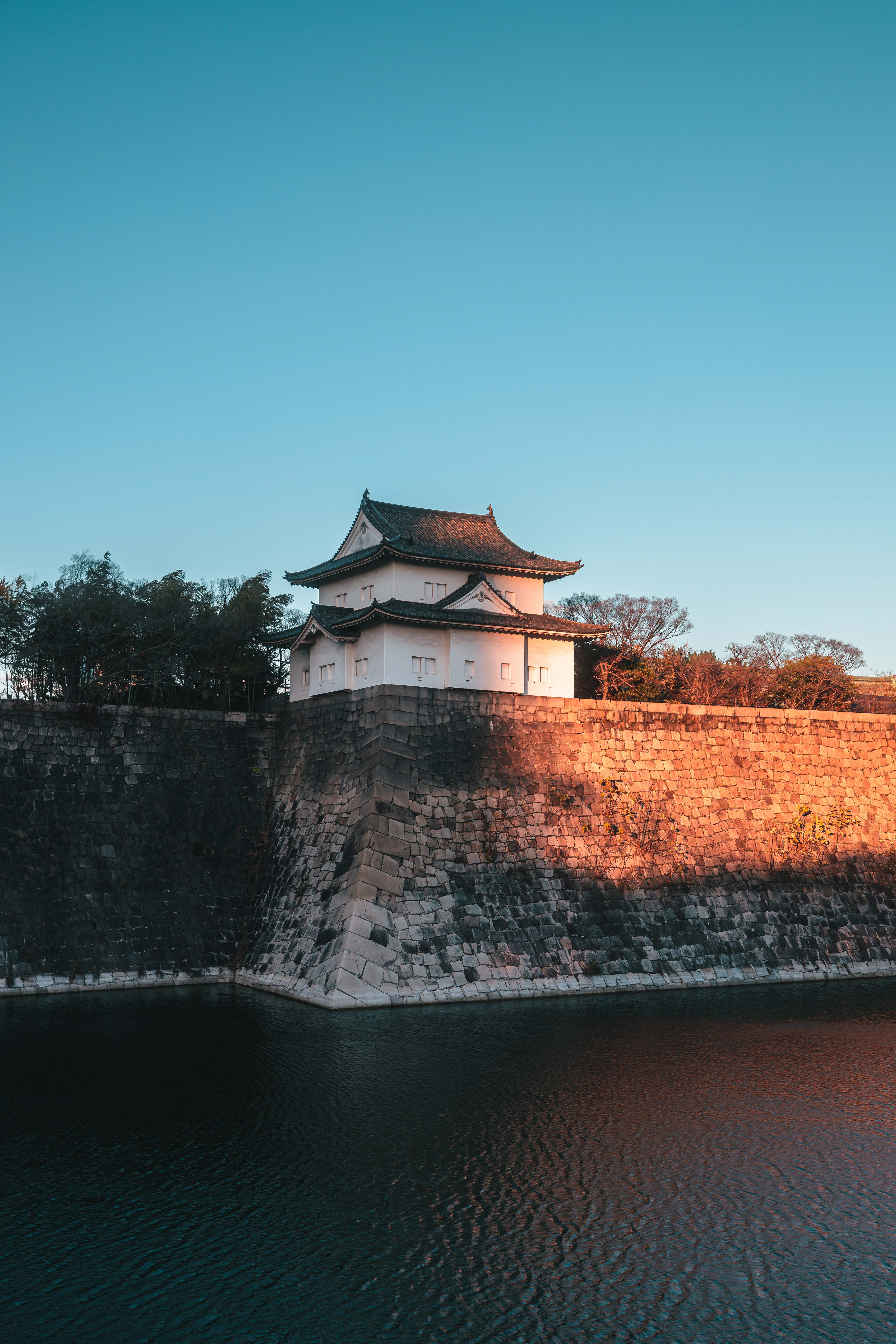 One of the towers of Osaka castle during sunset.