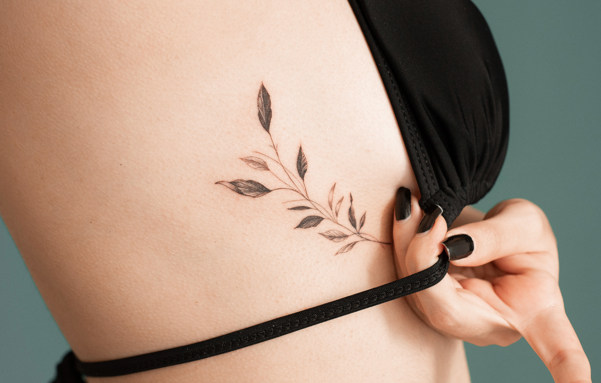 Floral tattoo on rib (detail) / fine-line tattoo