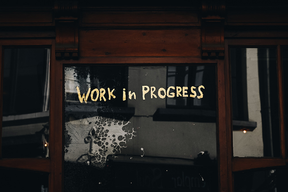 The words "Work in Progress" written on a window to show there's a content writing process involved.