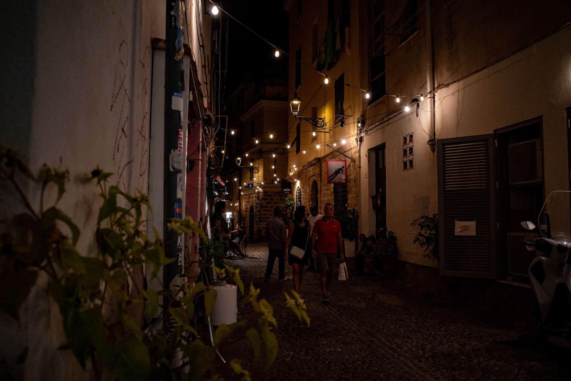 Lanterns and murmurs in the alley