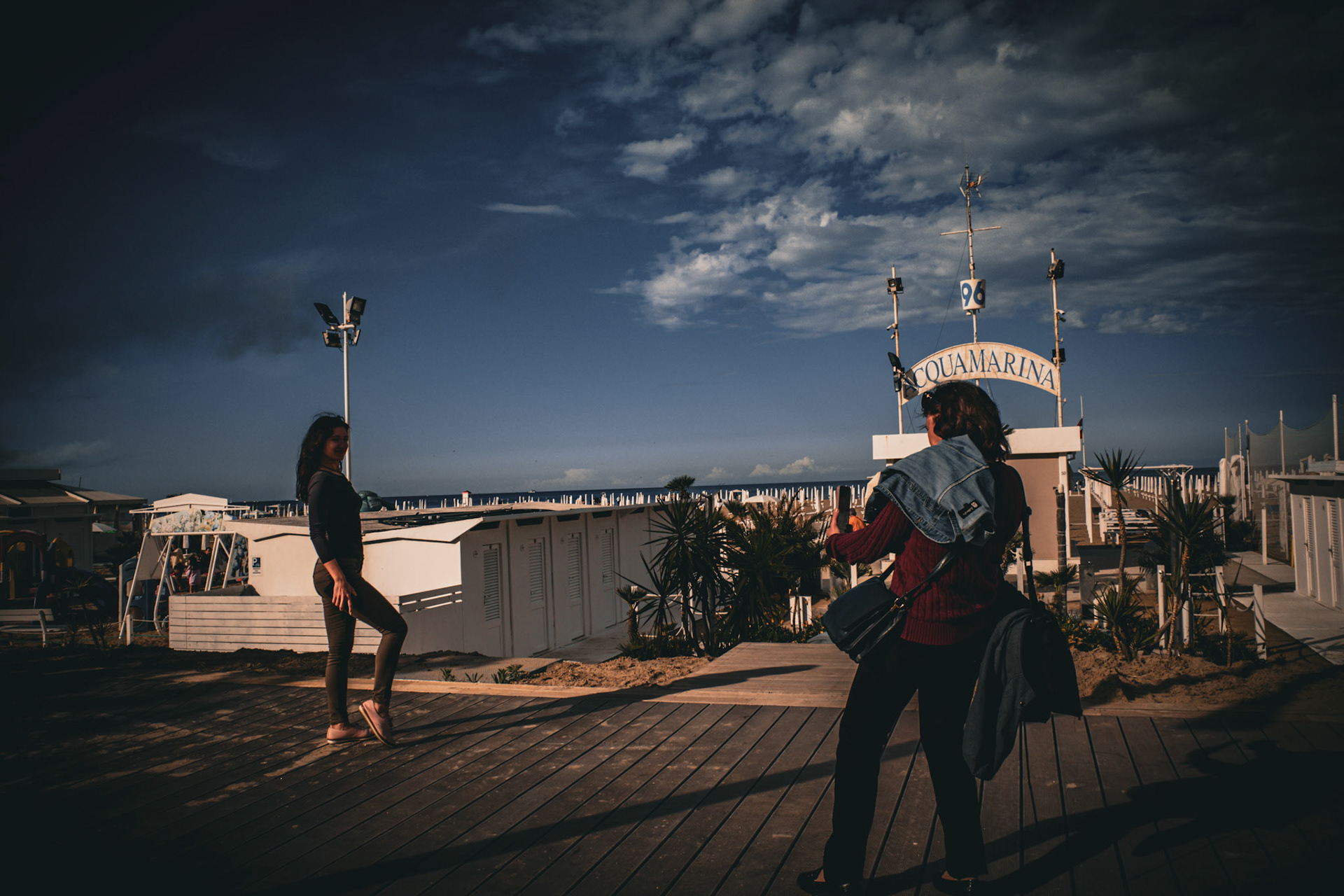Posing smiles in seaside shadows