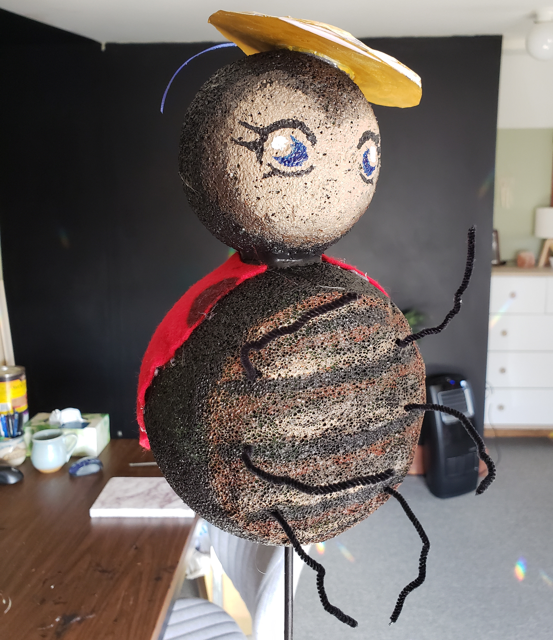 Prop made out of styrofoam balls, felt and paper.