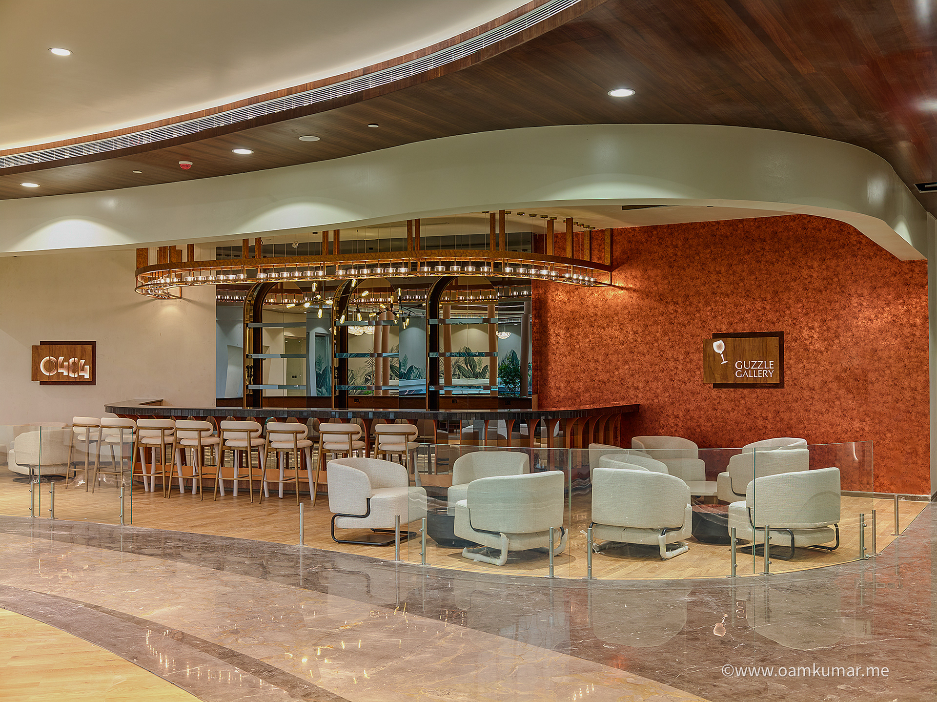 Contemporary bar in the '0484' lounge at Cochin International Airport Ltd (CIAL), featuring a sleek counter, ambient lighting, and a sophisticated atmosphere, photographed by Oamkumar Thottungal.