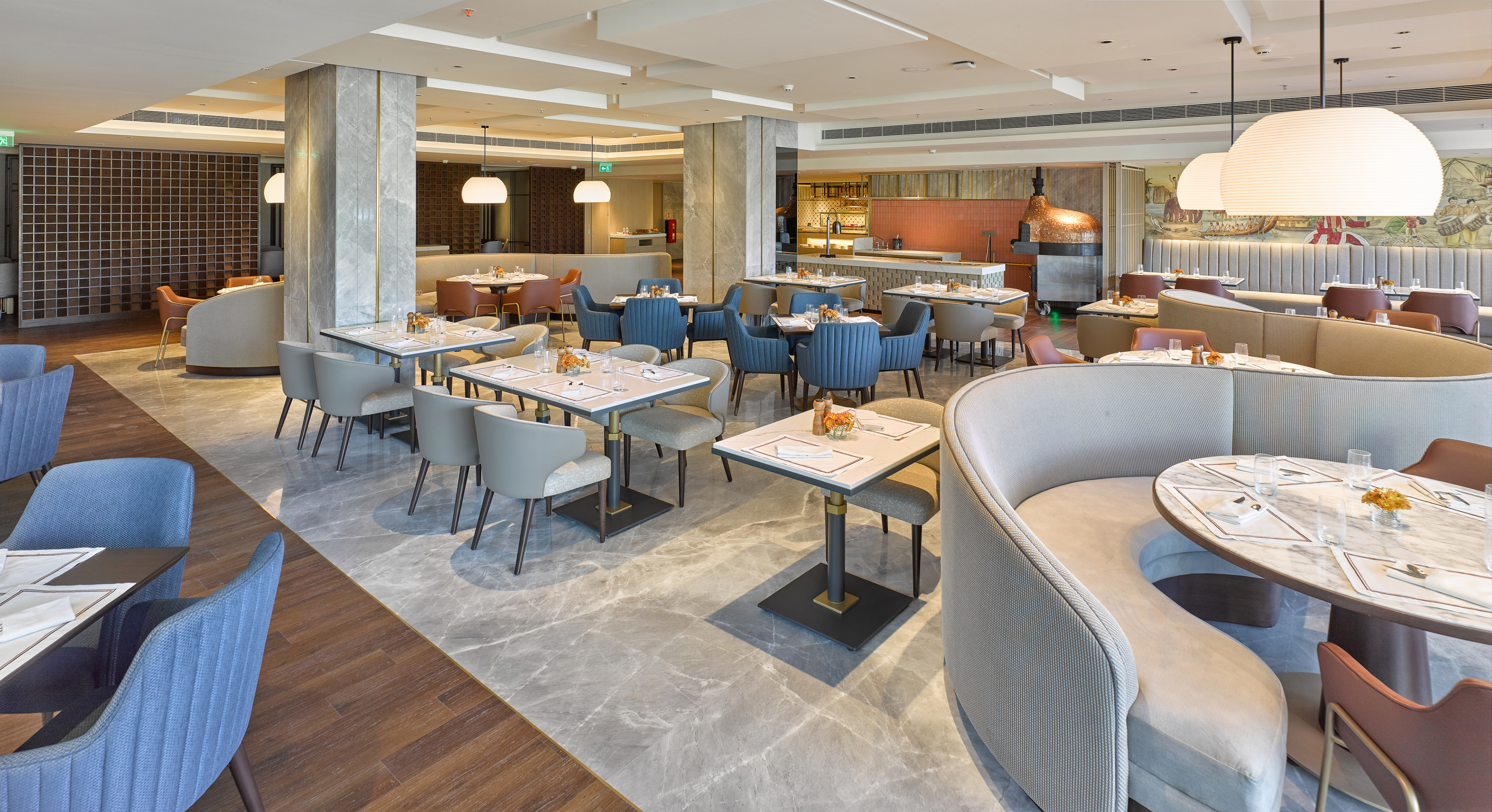 Chic restaurant at Taj Hotel near Cochin International Airport, featuring stylish interiors, ambient lighting, and a fine dining setup, photographed by Oamkumar Thottungal.