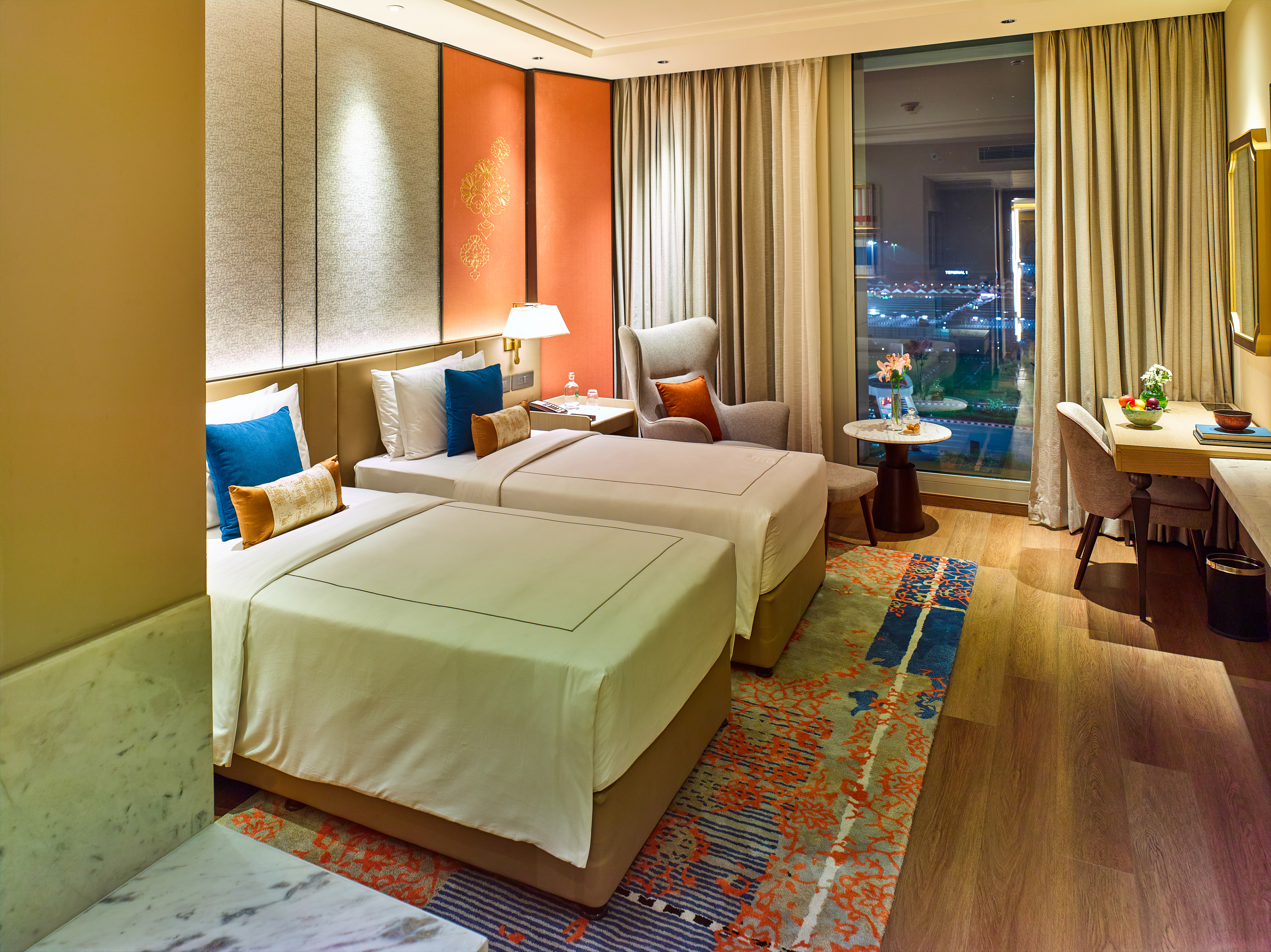 Luxurious double room at Taj Hotel near Cochin International Airport, featuring modern furnishings, a cozy ambiance, and a stunning airport view, photographed by Oamkumar Thottungal.