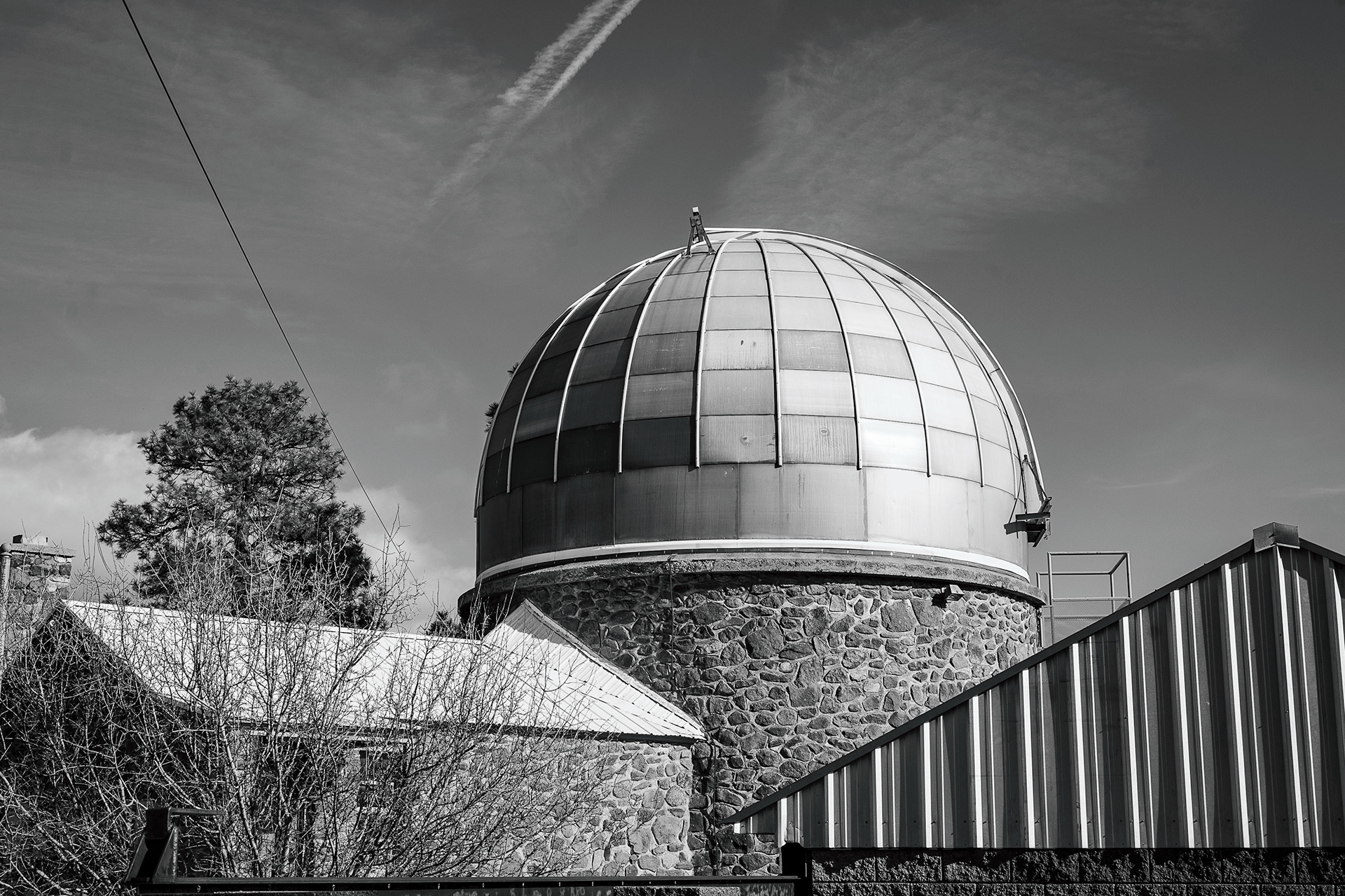 The Barry Lutz Telescope sits in the sun in Flagstaff. Before the semester got started, I got gifted a new lens for Christmas and wanted to take it for a city walk around campus. And there were a ton of clouds out. It made it all super sharp and created a really nice bit of contrast from the sky. I loved the texture that I was able to get on the building too. Taken on the Canon RF 50mm f/1.8. January 2, 2026.