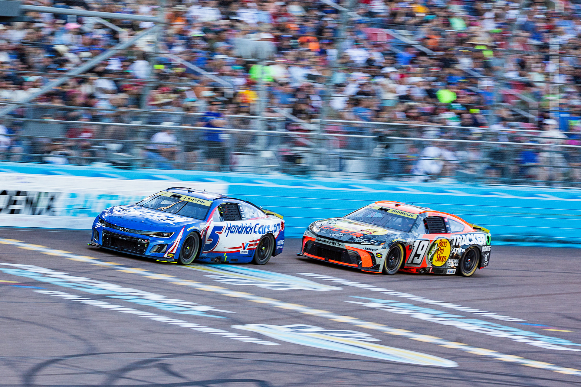 Kyle Larson (left) and Chase Briscoe (right) complete a lap of the NASCAR Cup Championship Series at Phoenix Raceway, Nov. 2.