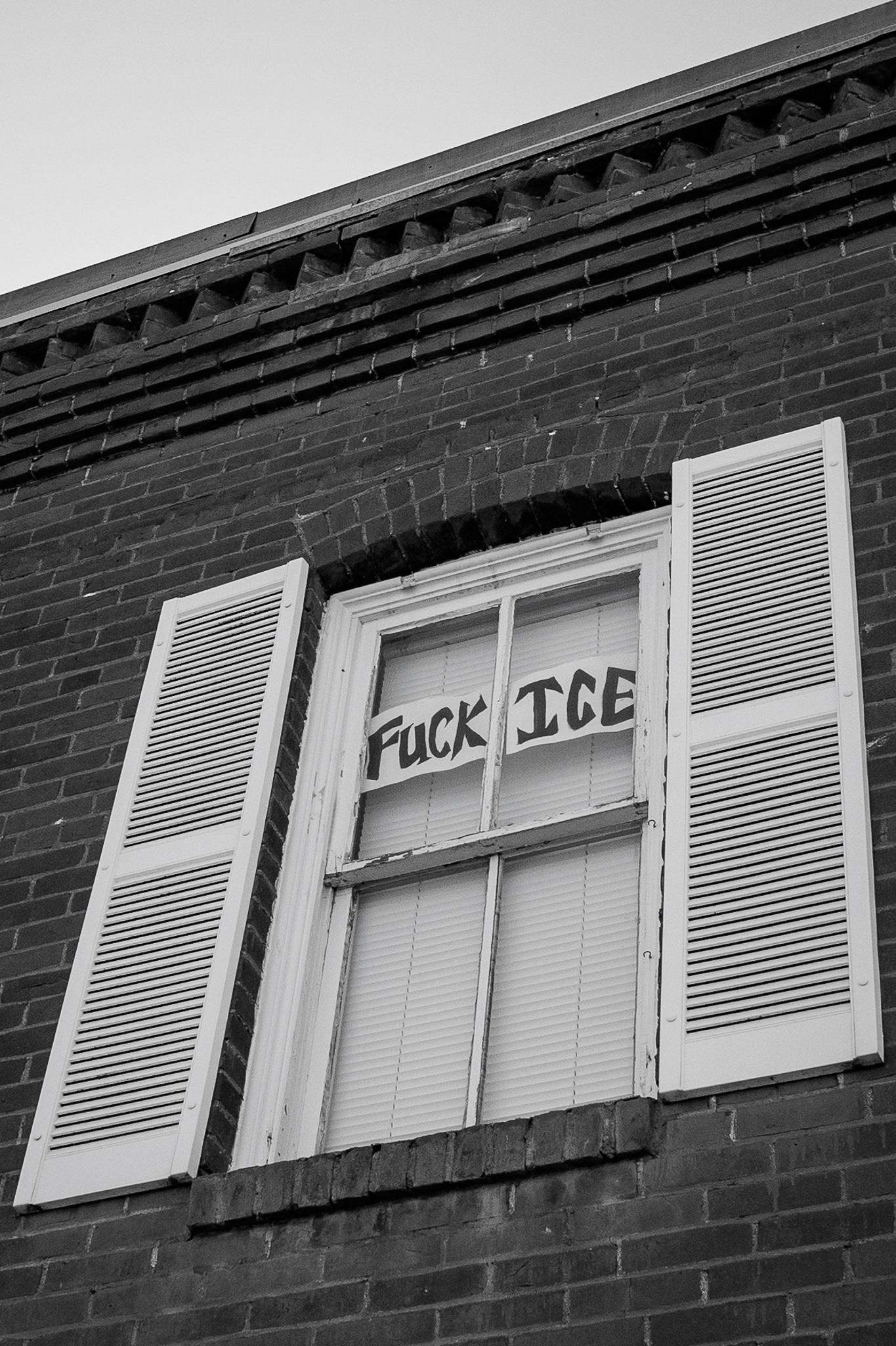 A house with an expletive sits in a window in Flagstaff. This was something that I didn't really anticipate taking a photo of. But I really liked the contrast that came from the windows from the brick. It was also something that was political. I never really take photos of things like this, and I really want to make photos that make a difference. And this is one of those photos that could make an impact. Taken on the Sigma 20mm f/1.4 Art Lens. March 5, 2026.  