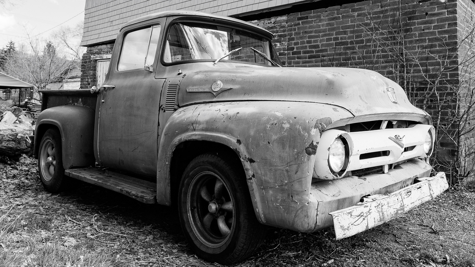 An old Ford truck sits in a driveway in Flagstaff. I really liked the texture that I was able to get on the truck. That was mainly due to the diffused light that was coming from the clouds. It really made the older tires and front grill really come out in post production. Taken on the Sigma 20mm f/1.4 Art lens. March 5, 2026. 
