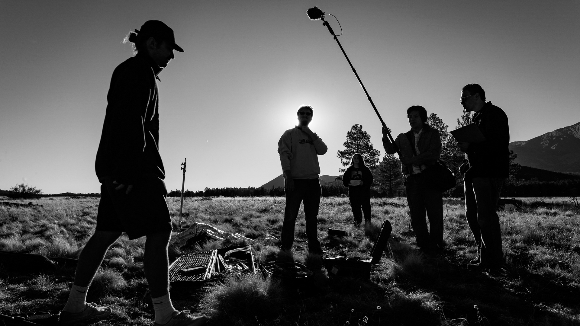 The crew for We Weren't Meant To Be Saved sets up a scene in the field behind The Chapel of the Holy Dove. Day two of shooting for this short film started out super early. We got out to the site right around sunrise. And I knew that I wanted to use the sunrise to my advantage. So as they were getting  the scene ready, I had the idea of wanting to try and go for a silhouette look. I really liked how I was able to not only get the silhoutte look but also get all of the hair details from each distinct person. Taken on the Sigma 24-70 f/2.8. March 21, 2026.  