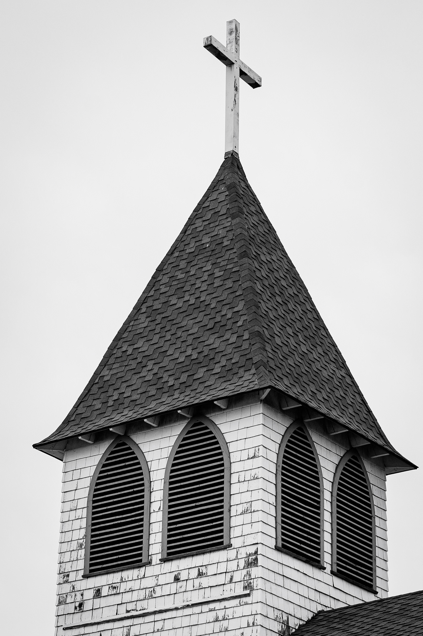 A spire of the Flagstaff Christian Fellowship in Flagstaff.  I really loved the overall mood of the photo. I loved how the clouds worked super well for the texture that is on the building. The diffusion of the clouds really helped bring out the details in the roof of the church as well as the sides of the spire. Taken on the Canon RF 50mm f/1.8. January 21,2026.