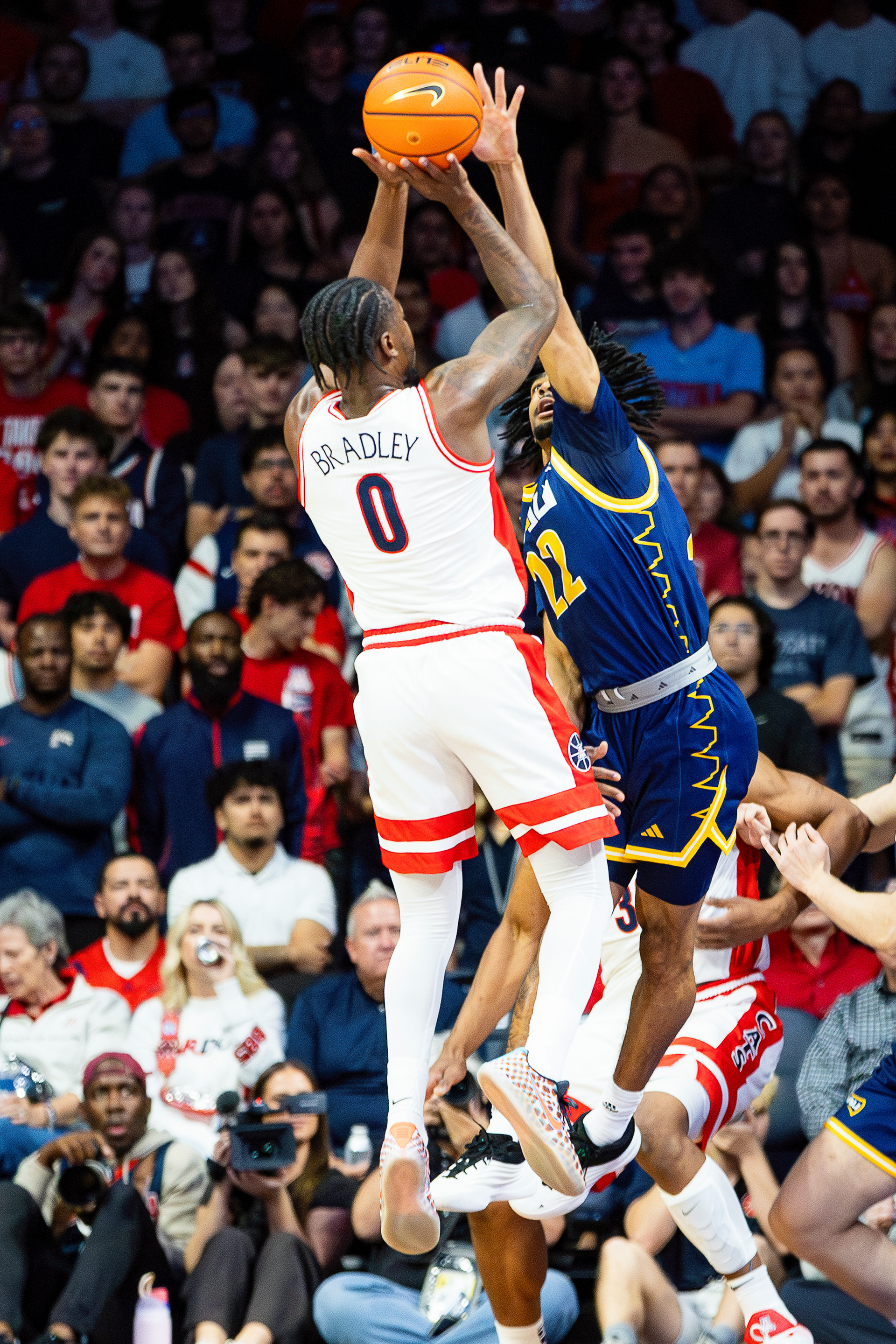 Soophomore guard Karvon Bullard (22) blocks Arizona senior guard Jaden Bradley (0) during the non-conference matchup at the McKay Center, Nov. 11. 