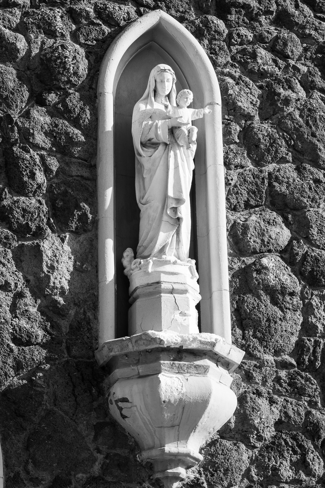 One of the statues on the outside of  the Church of the Nativity of the Blessed Virgin Mary in Flagstaff. This was another one of the things that I really wanted to photograph. I really liked how far away that this was, and honestly hadn't seen anybody take a photo of before. I also really loved the texture that was on not only the statue, but also on the brick of the statue. It is something that is super unique for me in this set. Taken on the Canon EF 135mm f/2.0. January 26, 2026. 