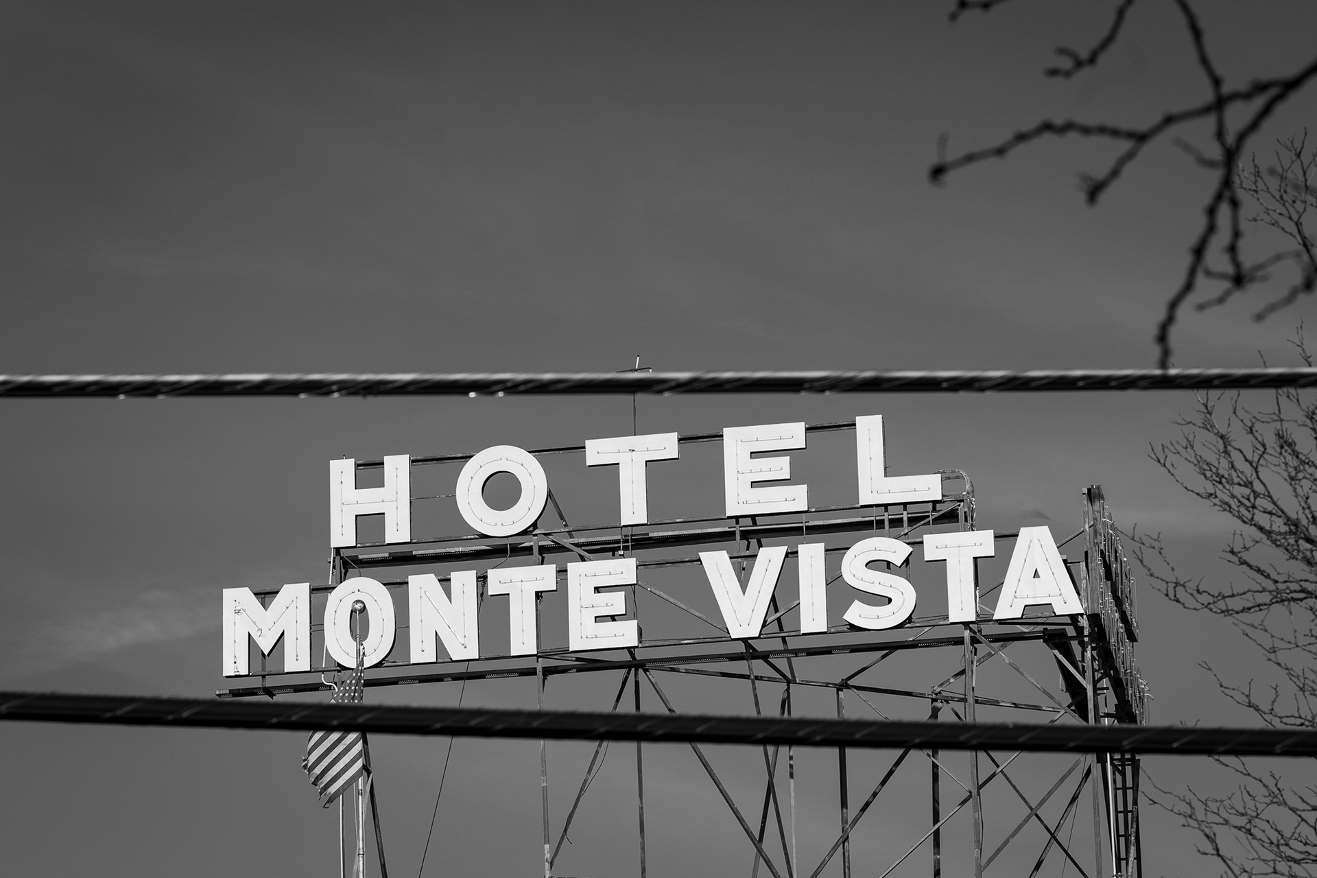The Hotel Monte Vista sign photographed between two power lines in Flagstaff. Using this lens was a big challenge to be honest. I have never used such a large focal length for street photography so it made me be super creative for composition. For the longest time, I had taken photos of the sign either head on at a weird angle. So as I was walking away from the sign, I noticed that these power lines were situated in such a cool way where it created this natural frame. Really proud of this one! Taken on the Canon EF 135mm f/2. January 26, 2026.