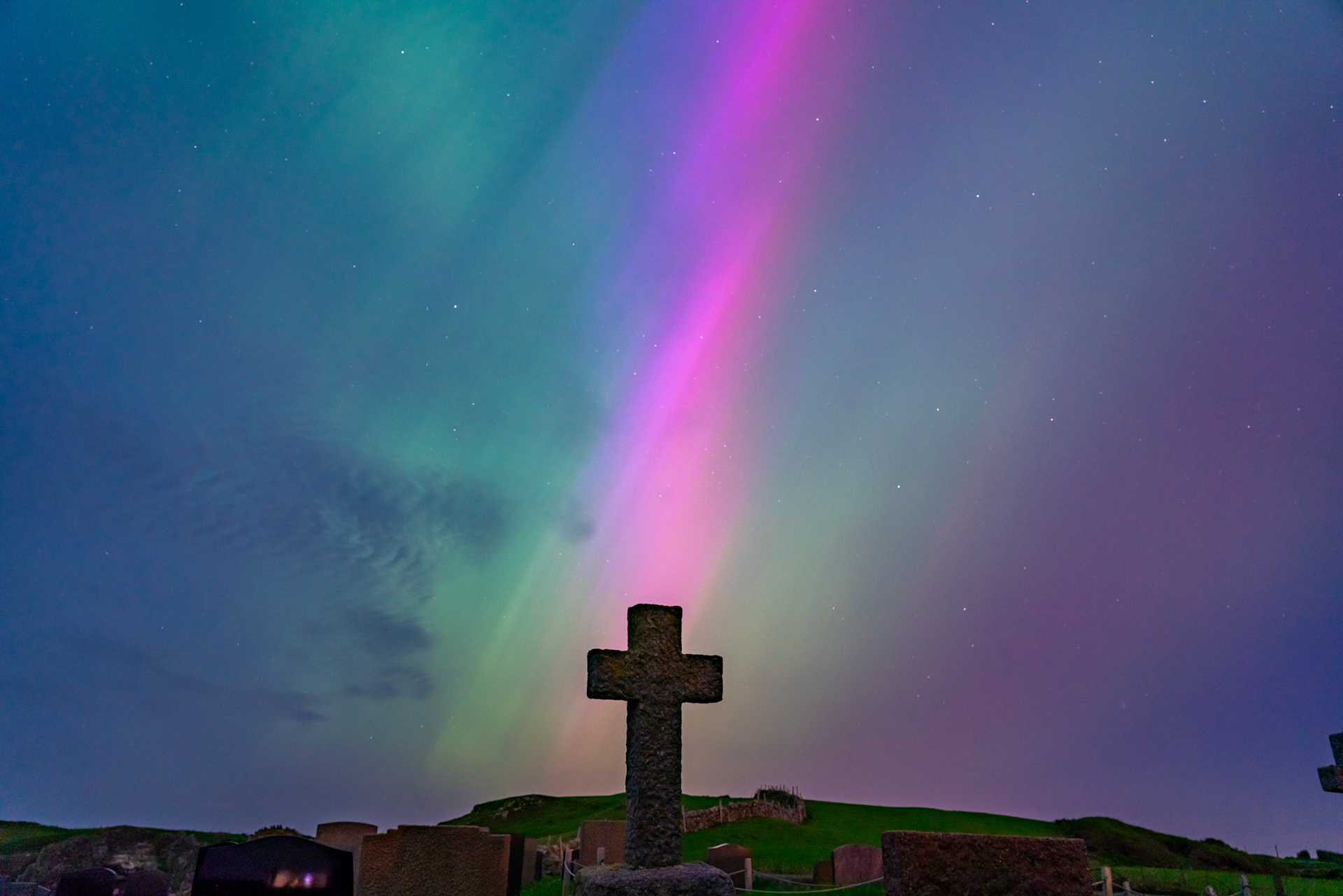 The Northern Lights in a graveyard on Anglesey Wales