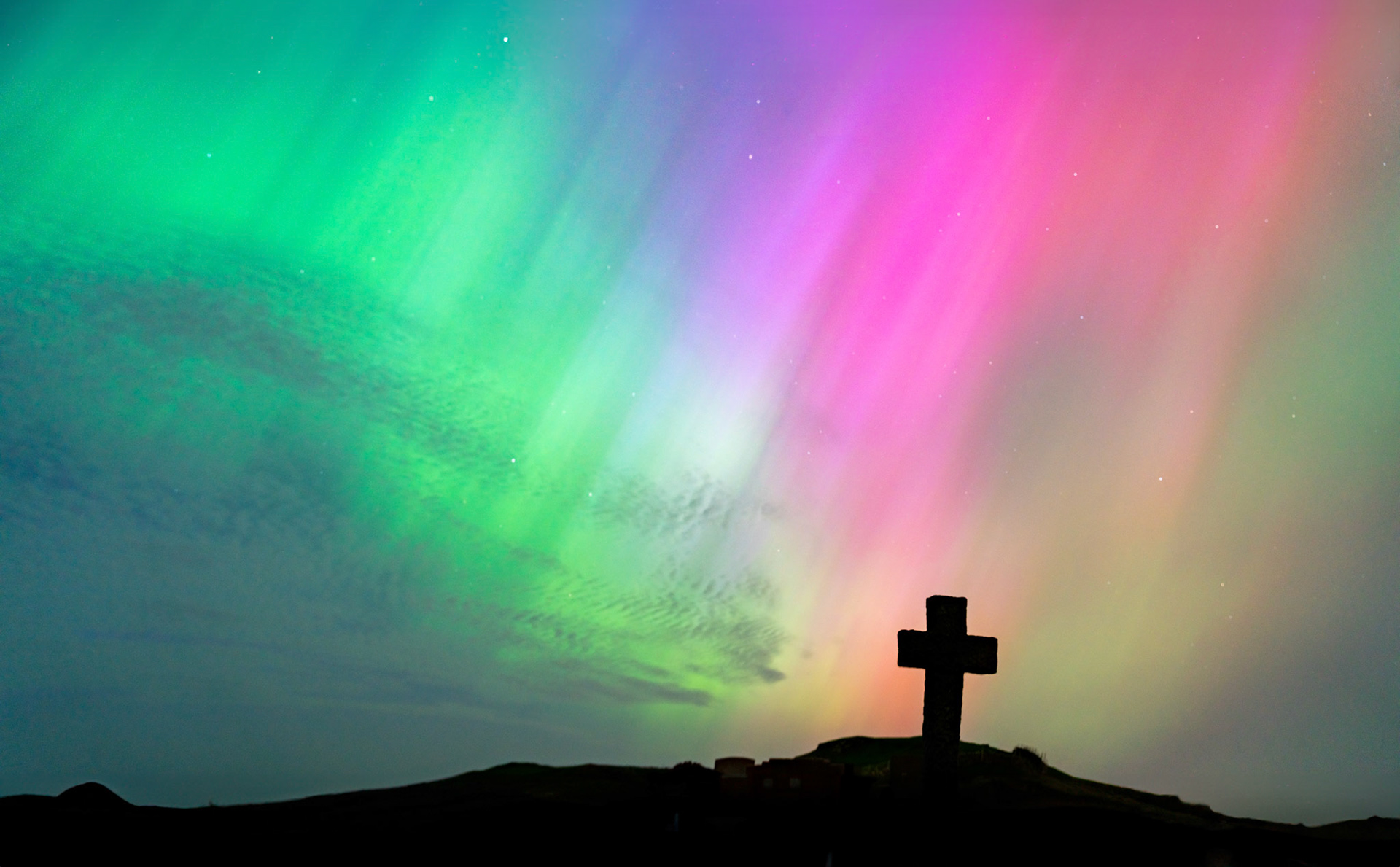 The Northern Lights in a graveyard on Anglesey Wales