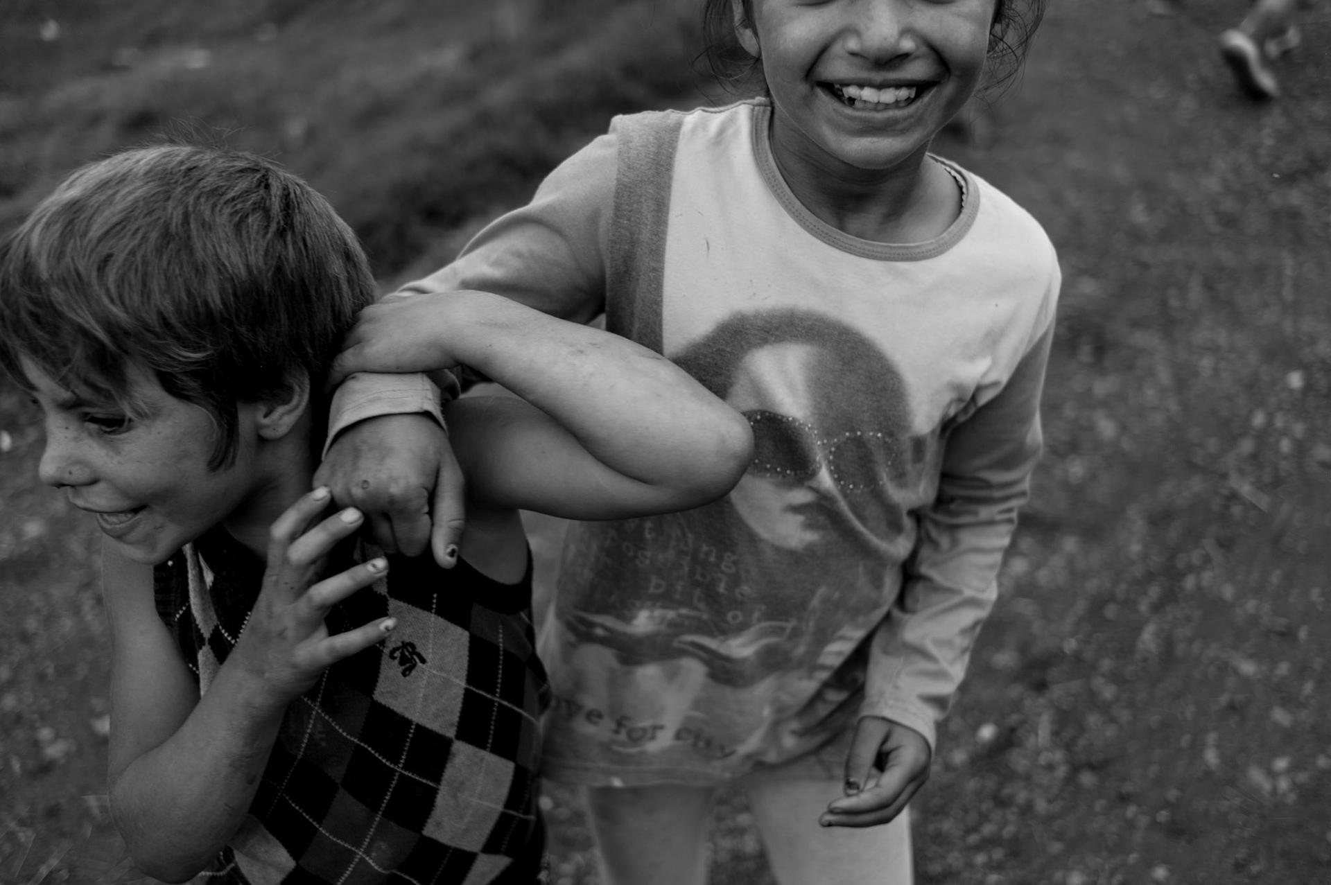 Siblings playing at a Roma village in rural Romania