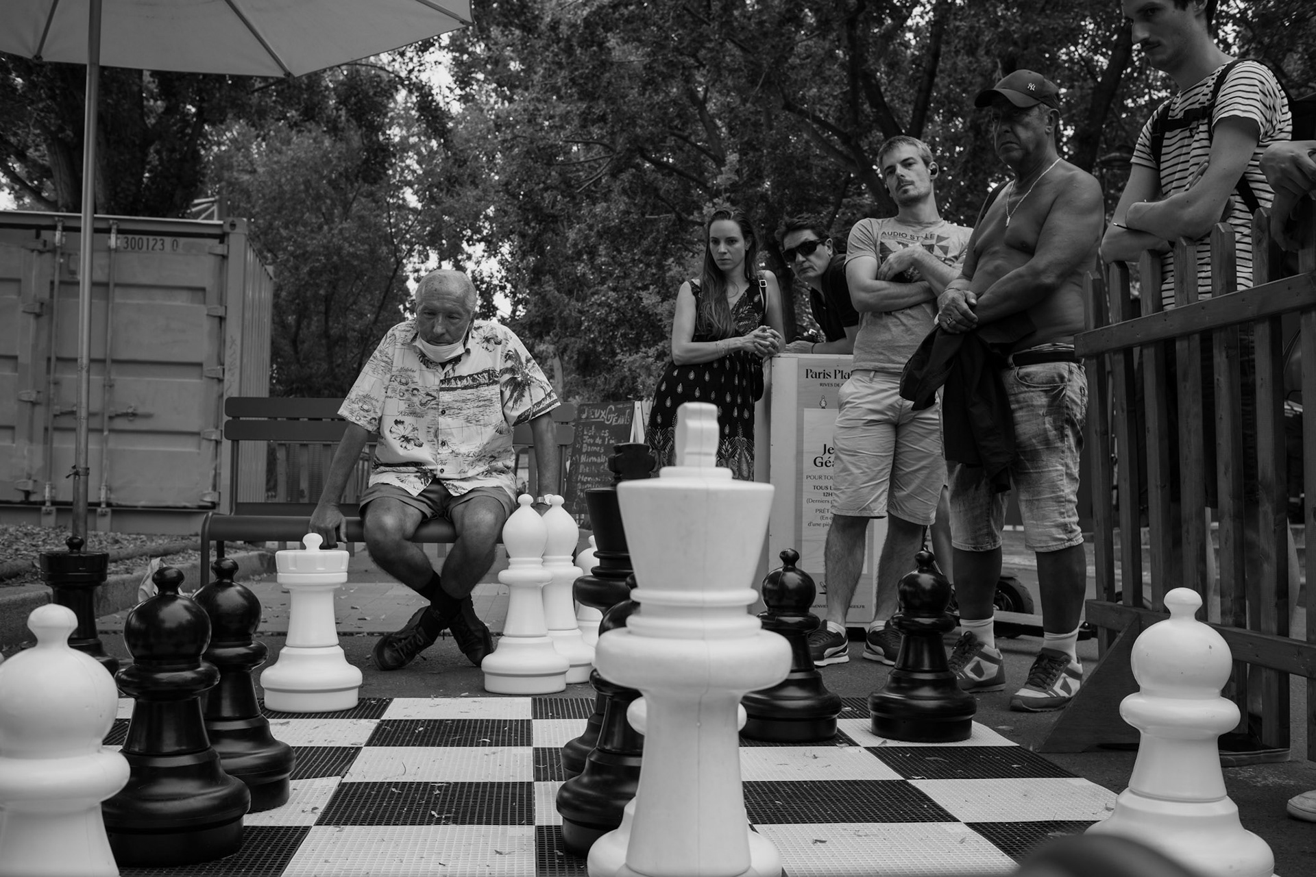 An older gentleman playing a public match of chess along the Seine canal in Paris, France