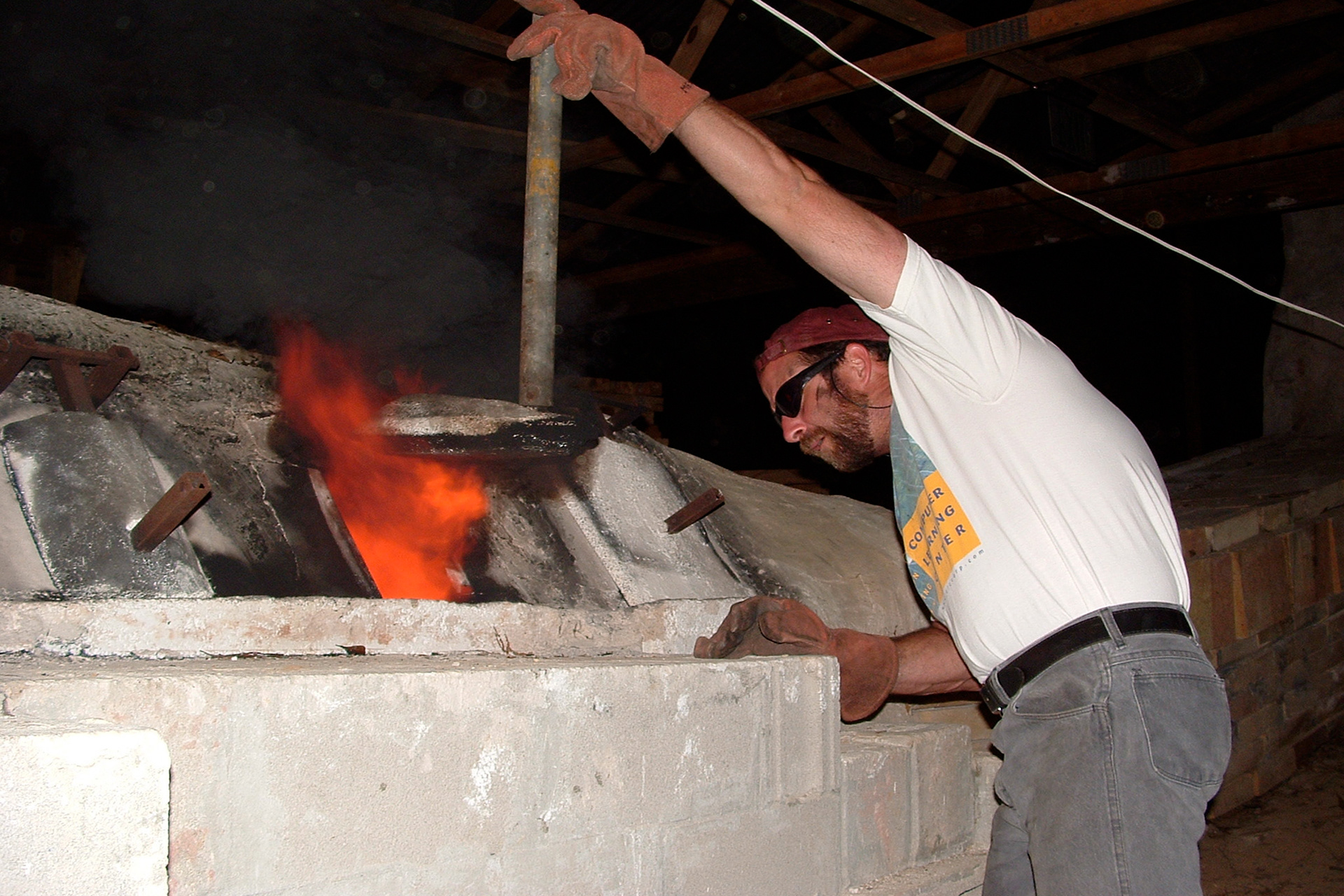 Meyer checking stoke hole at UM anagama kiln