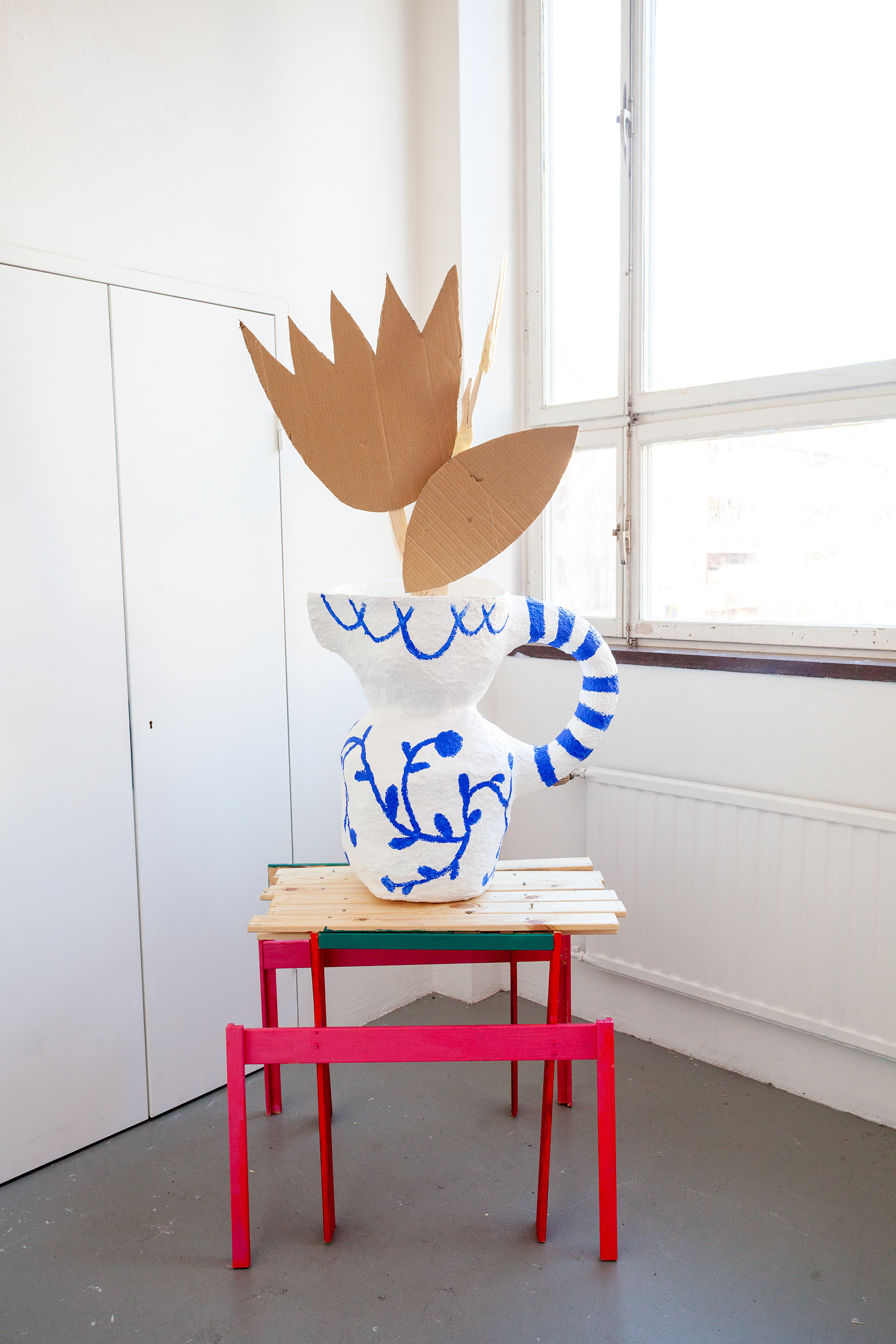 Blue and White Jug with Tulip on Sideboard (2025), papier-mâché, wood and cardboard