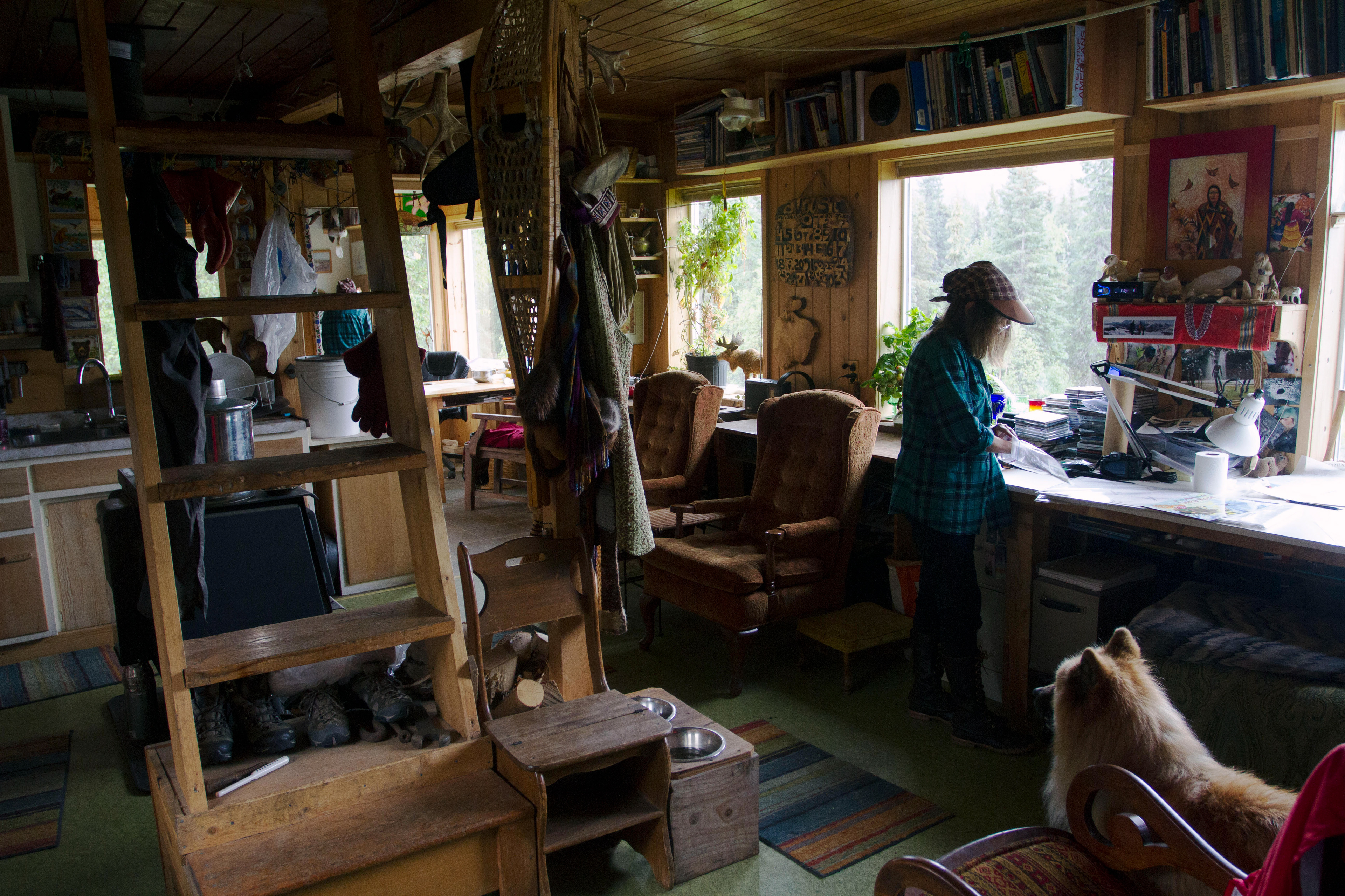 Shannon Cartwright roles up her artwork for her book “Alaska’s Animals, You and I” to send to town via the train on Monday, August 8, 2016. Cartwright said that she gets nervous every time she sends the originals through the mail, but her art has never been permanently lost.