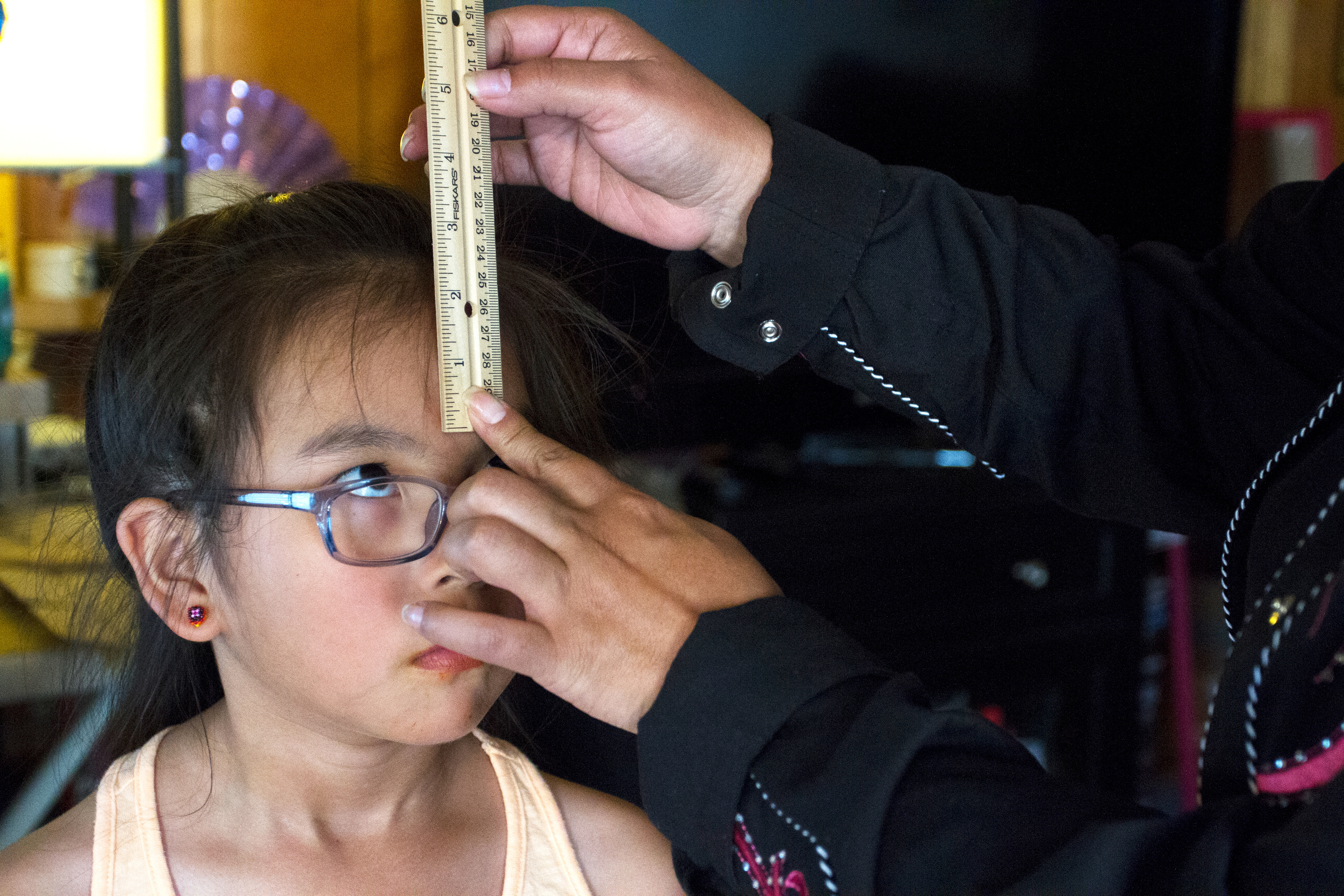 Sierra Balluta, 8, watches her mother measure her head to make a crown for the Eklutna Pow-wow Monday, June 13, 2016. A pow-wow princess is supposed to wear a crown at every pow-wow they attend that year to represent the pow-wow they were honored at.