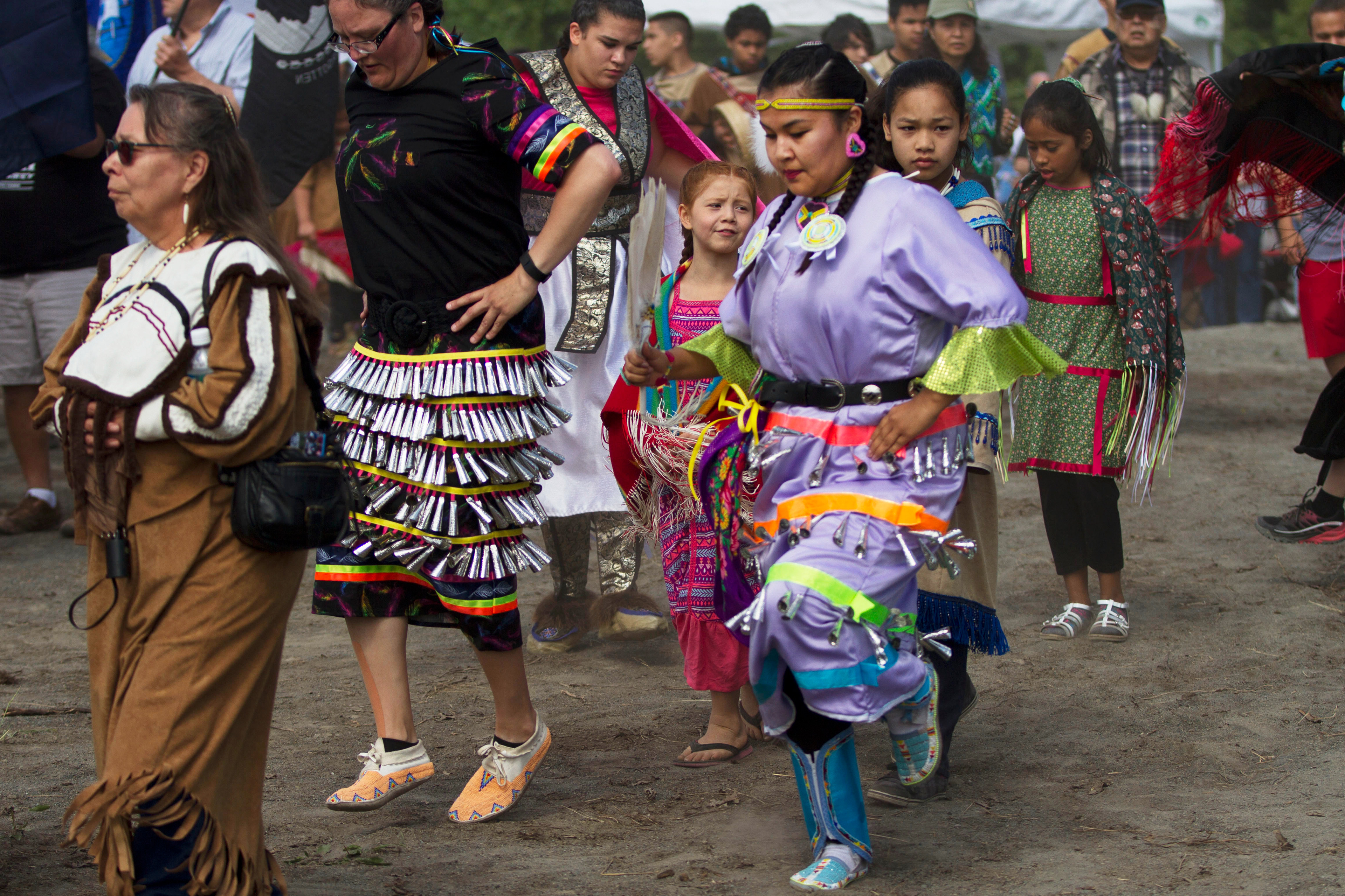 Katrina Deacon, 19, Jingle Dress dances during the Grand Entry at the Eklutna Pow-wow on Saturday, June 18, 2016. Katrina says that she tries to practice the dance every day at home.