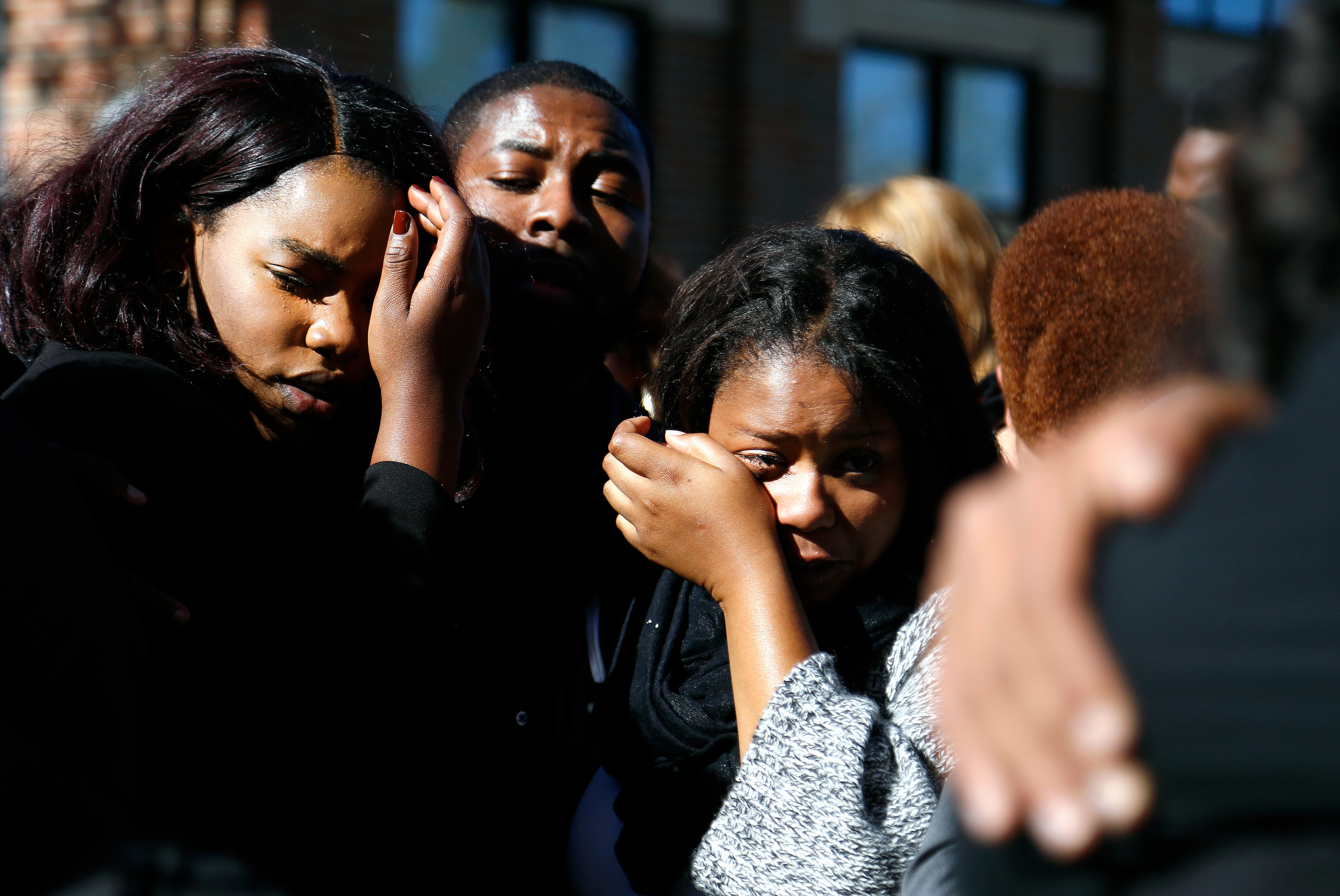 Members of Concerned Student 1950 hug each other and wipe tears after the group prayed together in front of the Reynolds Alumni Center on Saturday, Nov. 7, 2015. Concerned Student 1950 encouraged members to pray and encourage one another after the protest ended.