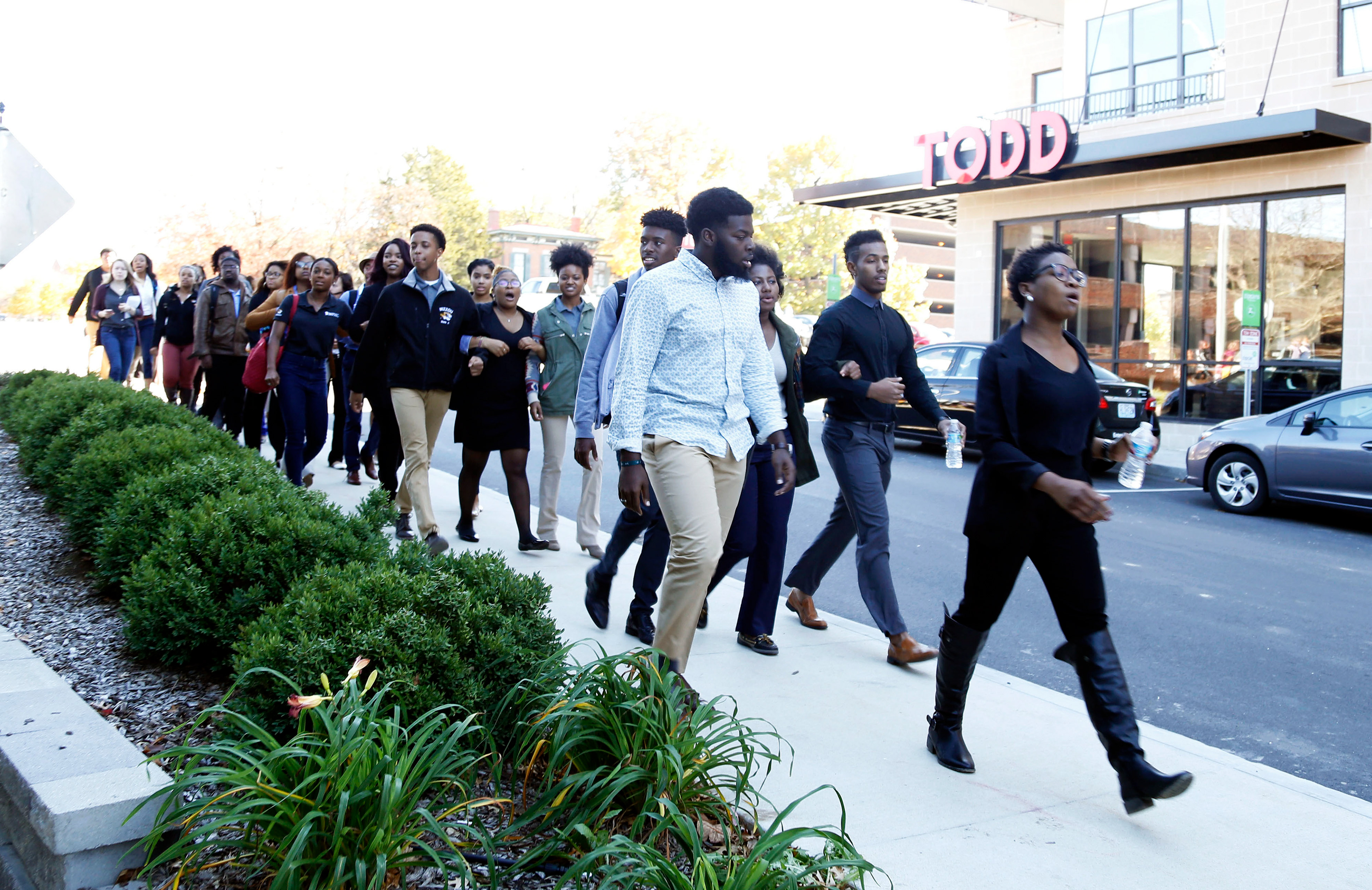 Concerned Student 1950 walks into the Mark Twain Dining Hall to protest the locations where the University makes money Saturday, Nov. 7, 2015. The students also marched to the Alumni Center, Memorial Union and the Student Center with a presentation of their stories of racism on campus.