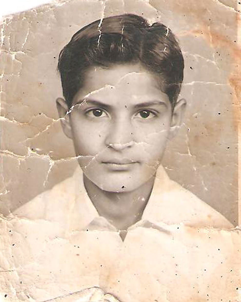 Old, distressed photo of a young man.