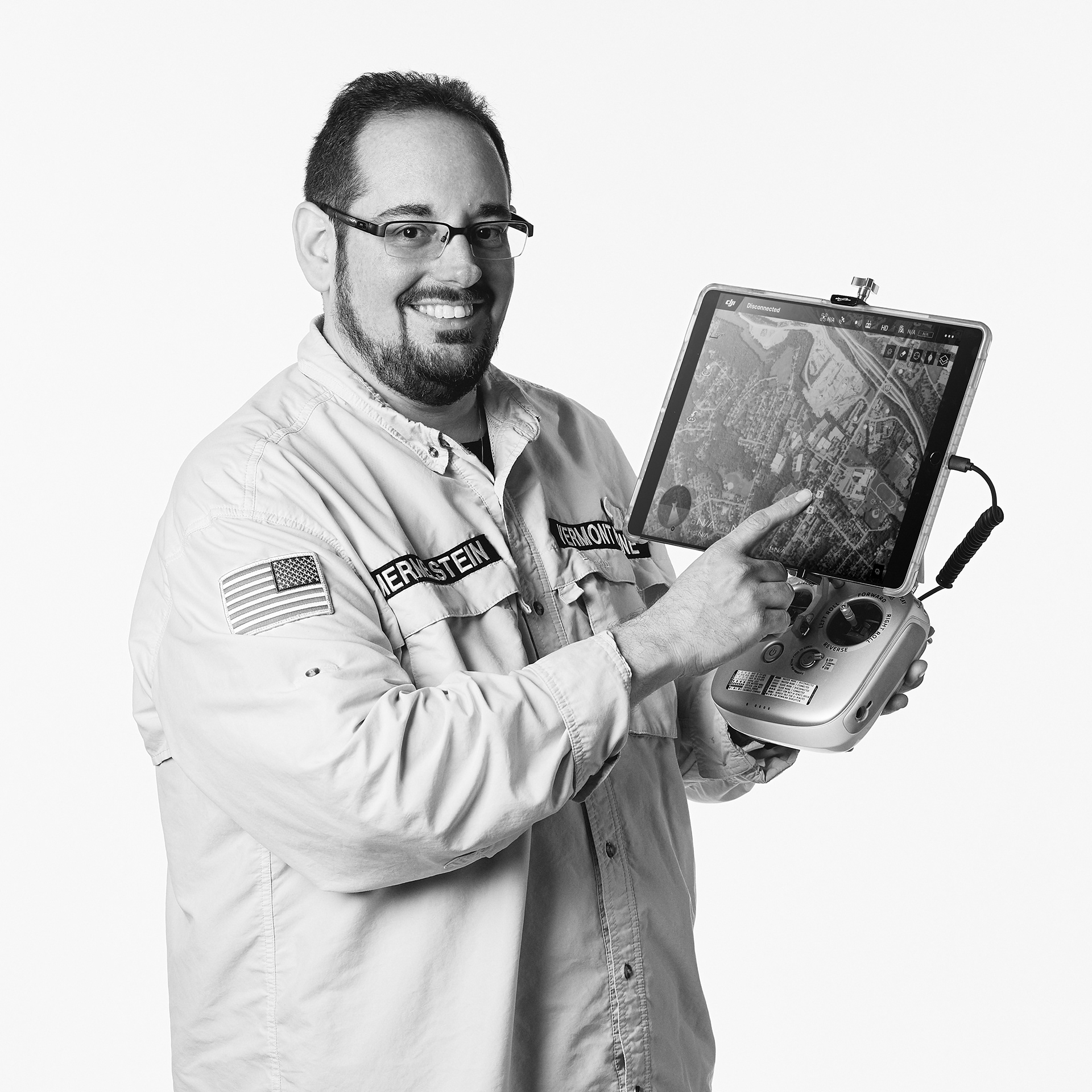 Photograph of Vermont Photographer and Cinematographer Steve Mermelstein holding a drone controller with attached iPad Pro.