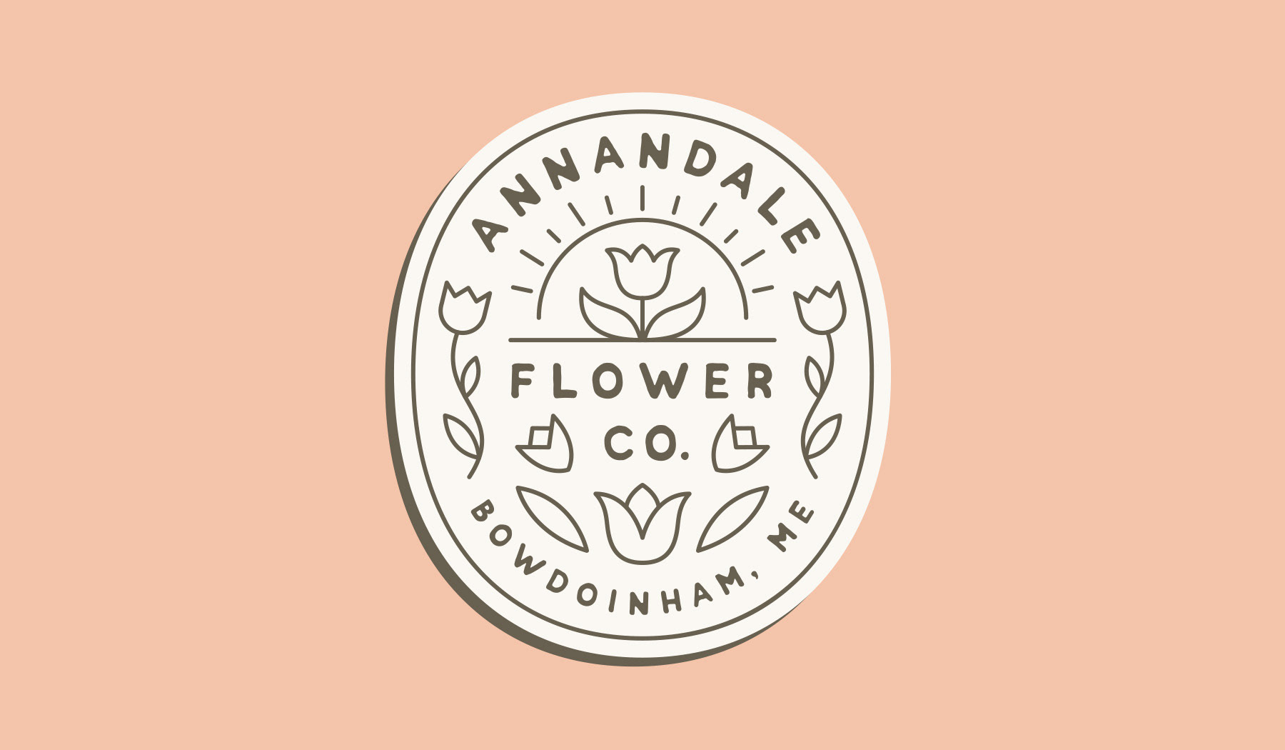 Oval logo design badge for Annandale Flower Co. in Bowdoinham, Maine, fearing simple flower graphics in an apothecary design style by Scott Whitehouse.