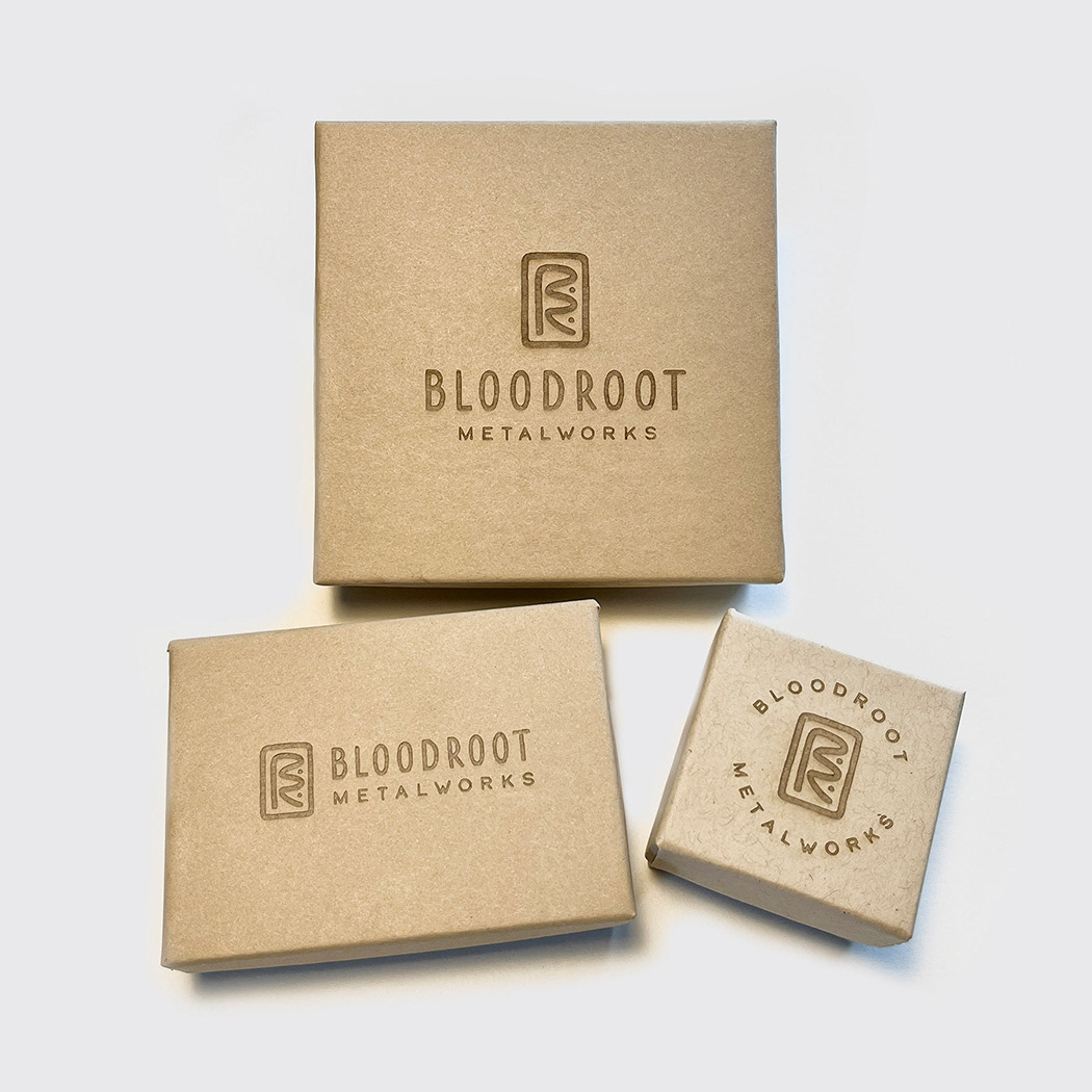 Packaging and jewelry box designs for Bloodroot Metalworks with engraved logo design by Scott Whitehouse.