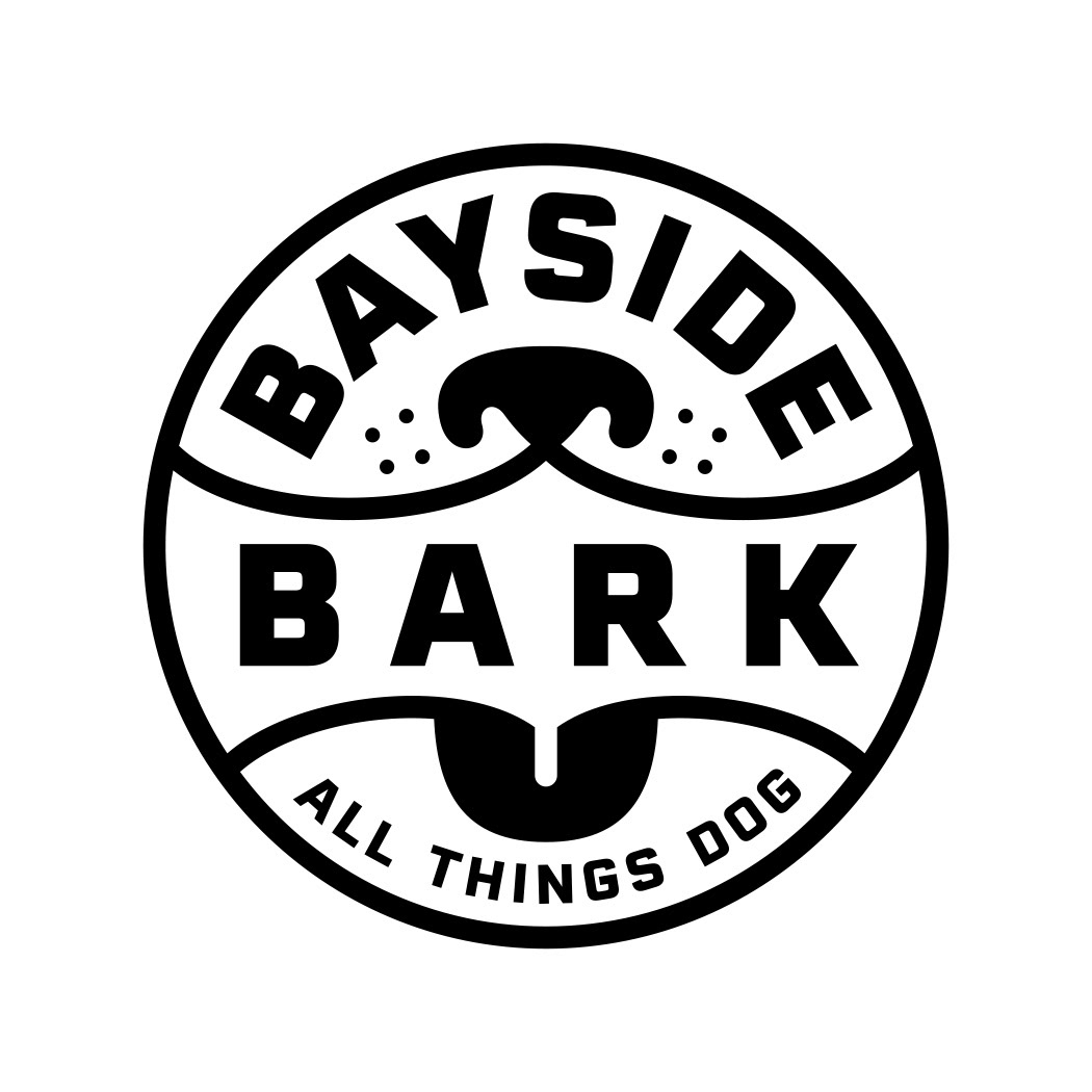 Bayside Bark Pet and dog supply store logo design, with the name Bayside Bark set inside a round badge design with simple and cute black and white graphics of a happy dog smiling and barking with tongue hanging out, along with the text tagline All Things Dog.