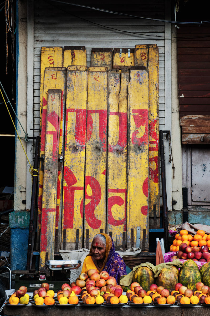 A fruit seller waits for customers at her stall in one of Mumbai's many neighborhood markets.