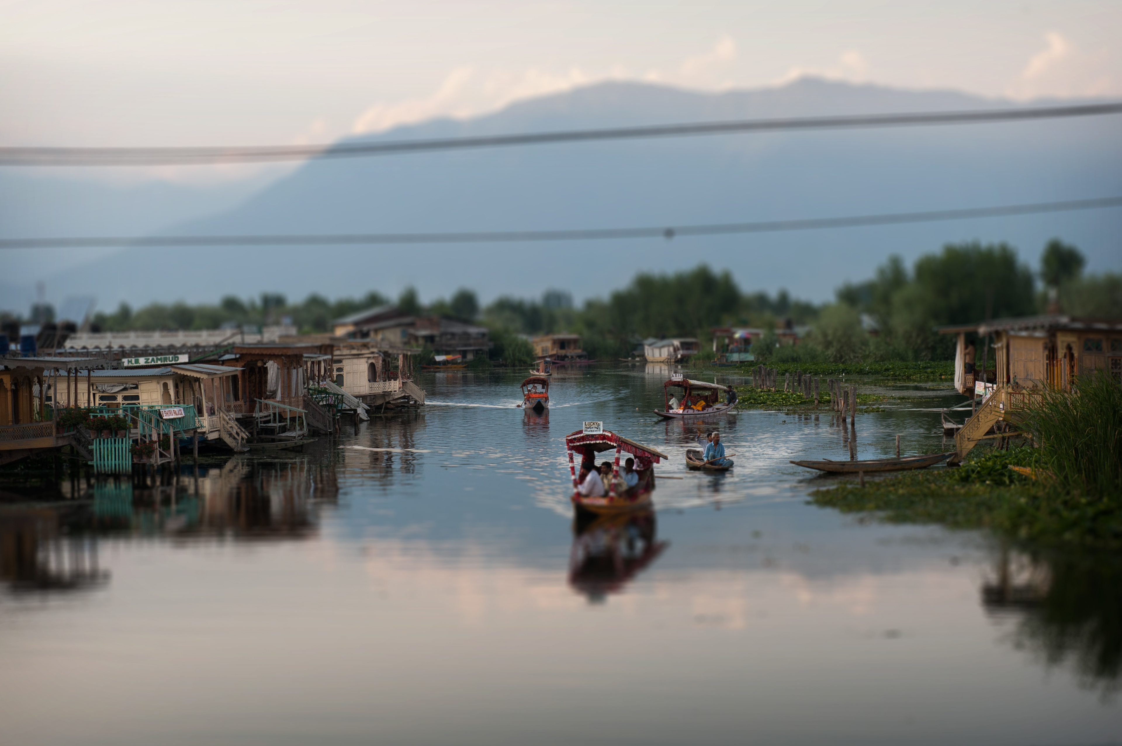 Residents and visitors navigate the waterways of Dal Lake, home to floating gardens, houseboats, and the iconic shikara boats of Kashmir.