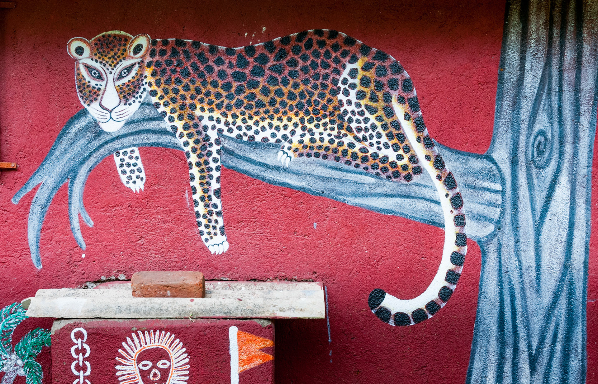 MUMBAI, INDIA – August 9 2018: Leopard painted on the wall of a Warli big-cat temple. Warli are indigenous tribal people. They live at SGNP in harmony with big cats, revering and worshipping them.