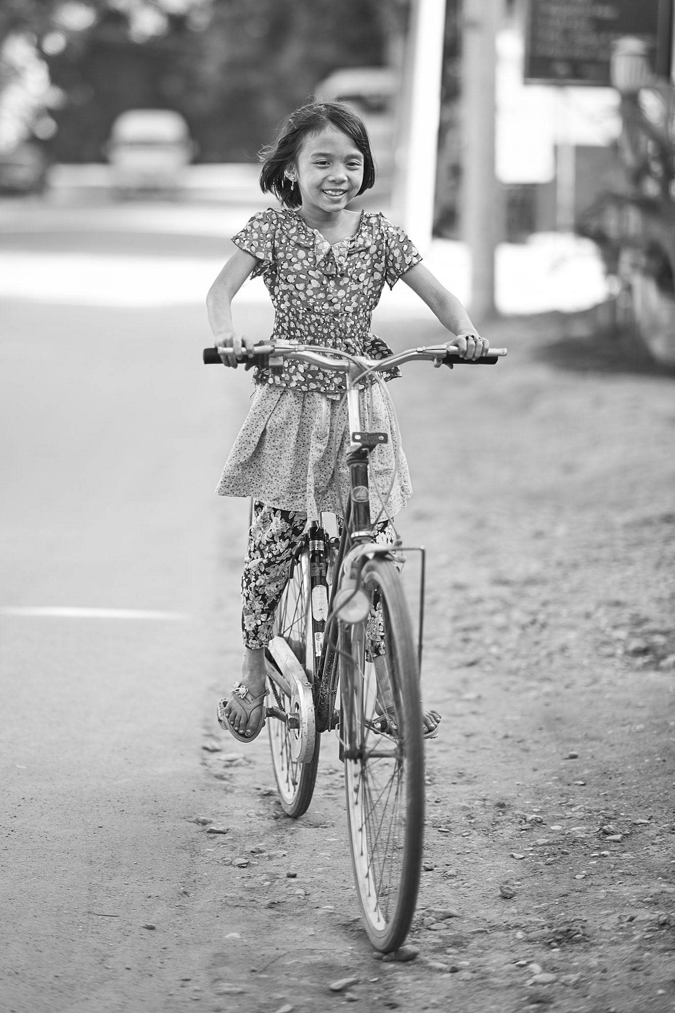 The joy of riding a bike, the joy of freedom and faster movement is so big for children. This girl was probably not older than 7 years but she was so happy riding her bike 2-3 times bigger than her.