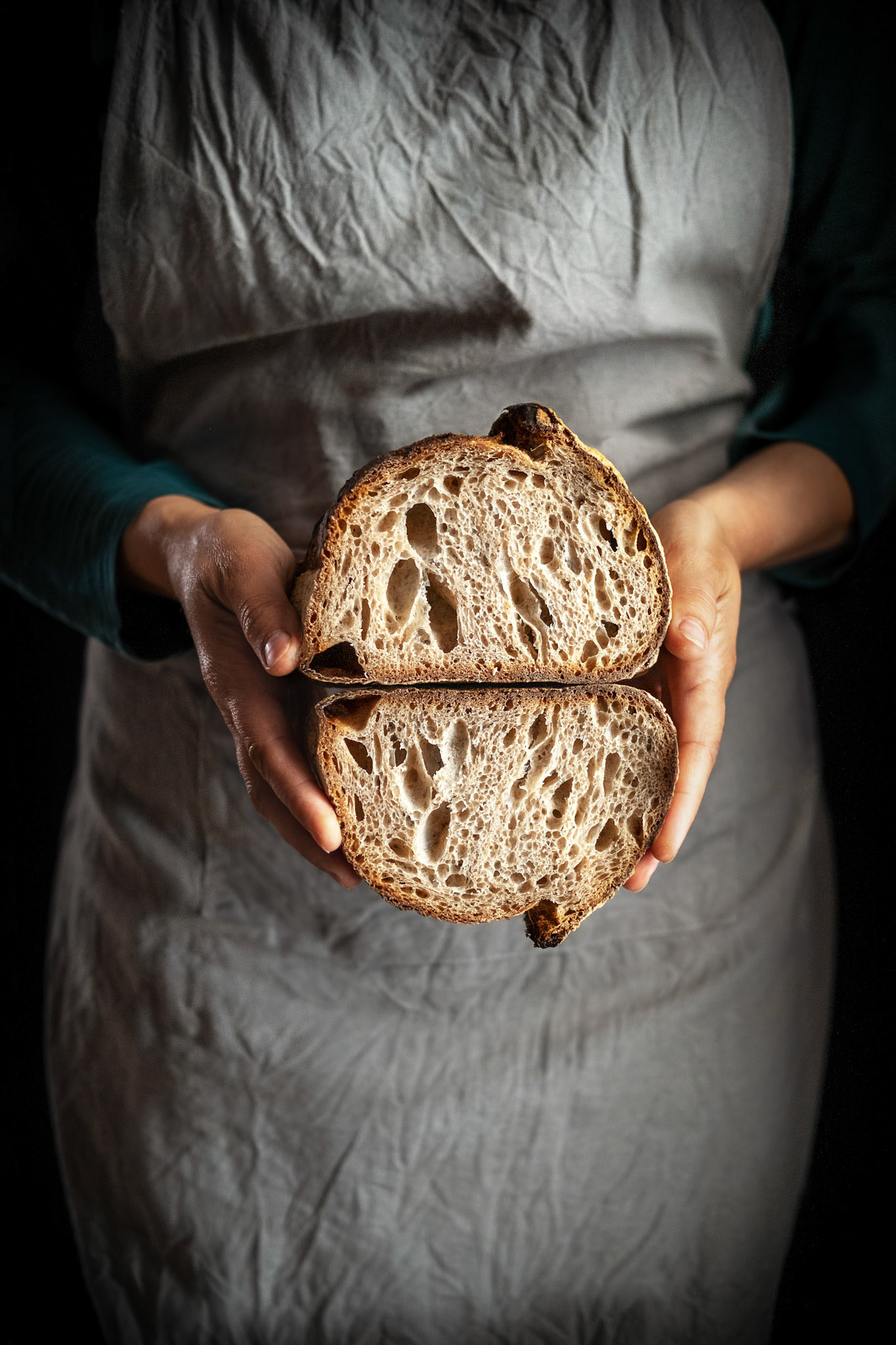 Whole wheat sourdough bread in the baker hands