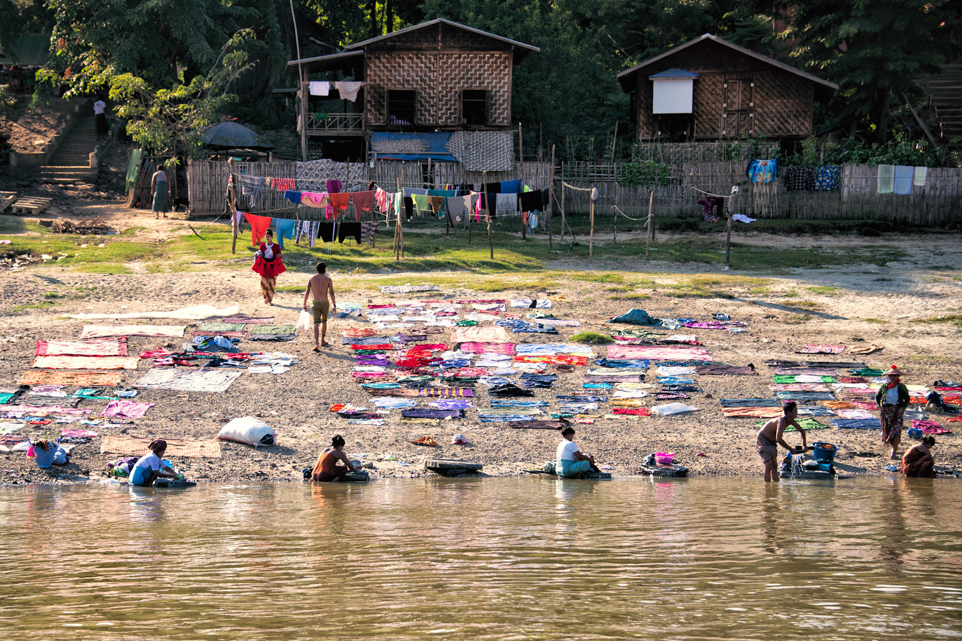 MINGUN, MYANMAR - NOVEMBER 25: People from Mingun washing and drying clothes in the traditional way on the 25th of November 2018 in Myanmar just before sunset.