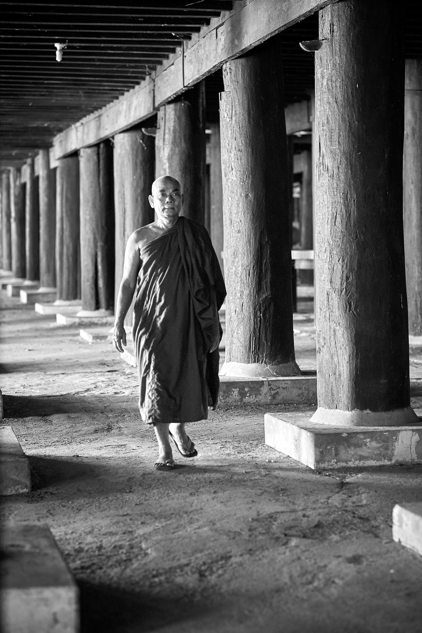 Another temple, a wooden one. I've seen others more shiny. A monk makes me a sign to come. I follow him with my bare feet. He shows me a stone house, open the lock of the door and he enters. I follow him. Inside there was a skeleton. A real one, with teaching purpose. He then shows me another locked room from another cottage, no windows and just a chimney with a fan on top, going outside. The room is painted with Buddhist scenes making you feel that everything was real. We go out, he shows me the space under the temple. A big place where you can lose yourself. There is my hospitable monk.