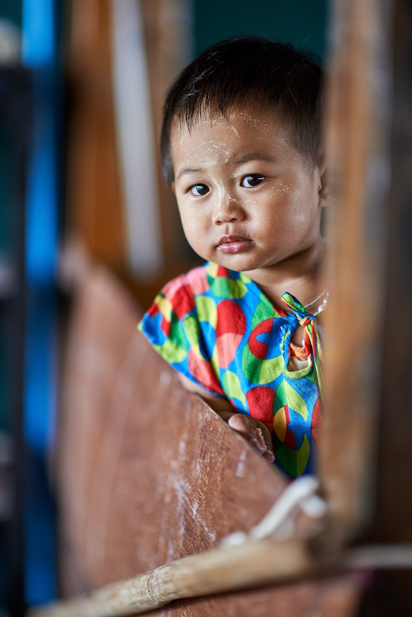 I was photographing people around when an English woman stopped me and told to go and visit a wooden house and look for a lovely little girl there. It was a bit weird why she gave me this info, but I felt I had to follow her advice. The moment I entered in a big room where some women were sewing in a very traditional way, a little girl almost jumped on my way with a happy smile. It was like she was waiting for me for a long time. It was like the sun rising in the morning. Her mother, a worker in this lotus and silk traditional factory,  put her on a big table on the side, that was looking more as a theatre scene. She danced for me almost for 15 minutes, radiating a happiness that you could rarely find. Photographing her it was not anymore my thing. I was just looking at her joy and let myself enter into her world. When it was the time for me to leave, she felt and she stopped, I grabbed the camera and make her some photos. That joy or that innocence from her eyes is difficult to be forgotten.