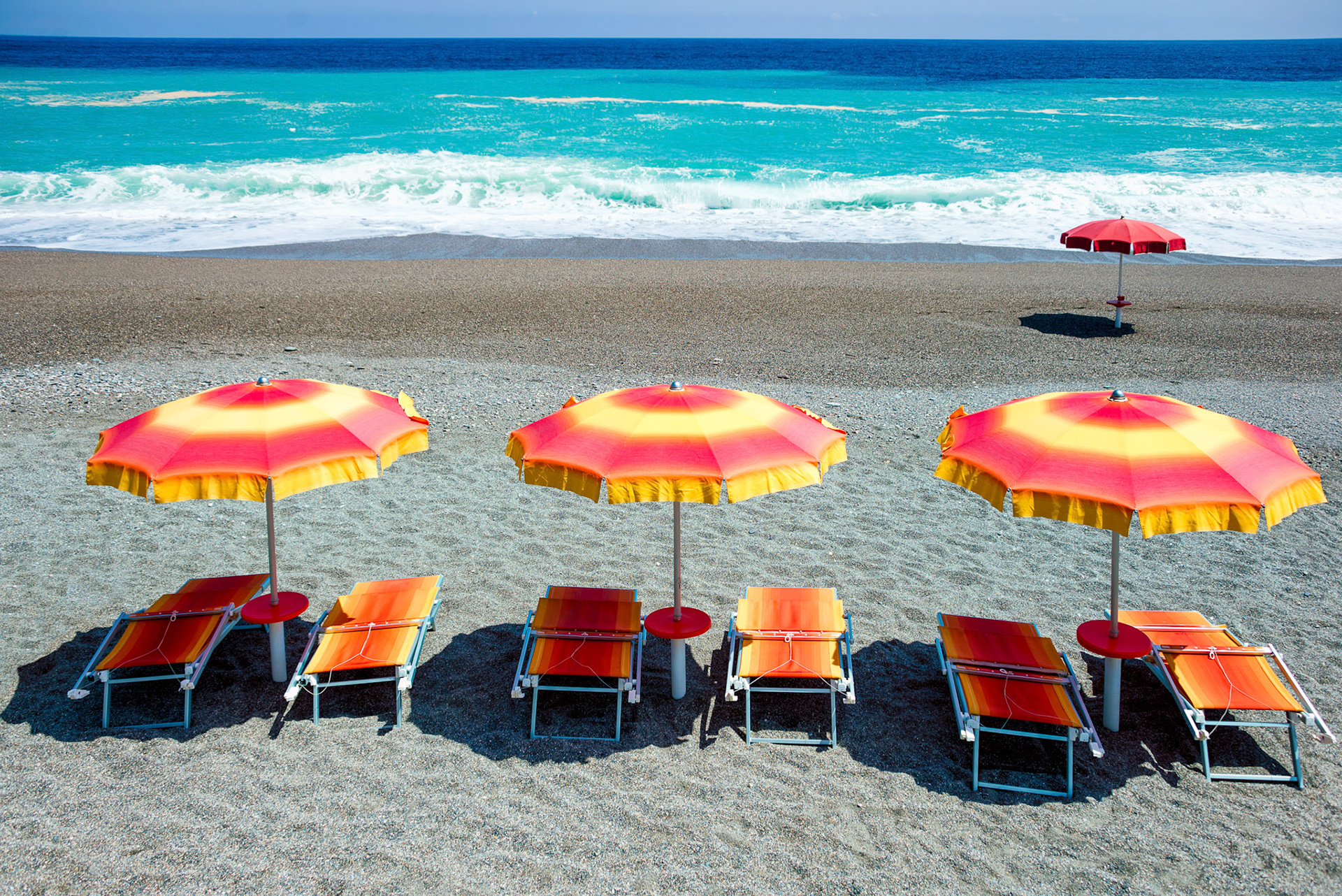 Sunbeds and umbrellas on a beach in Sicily